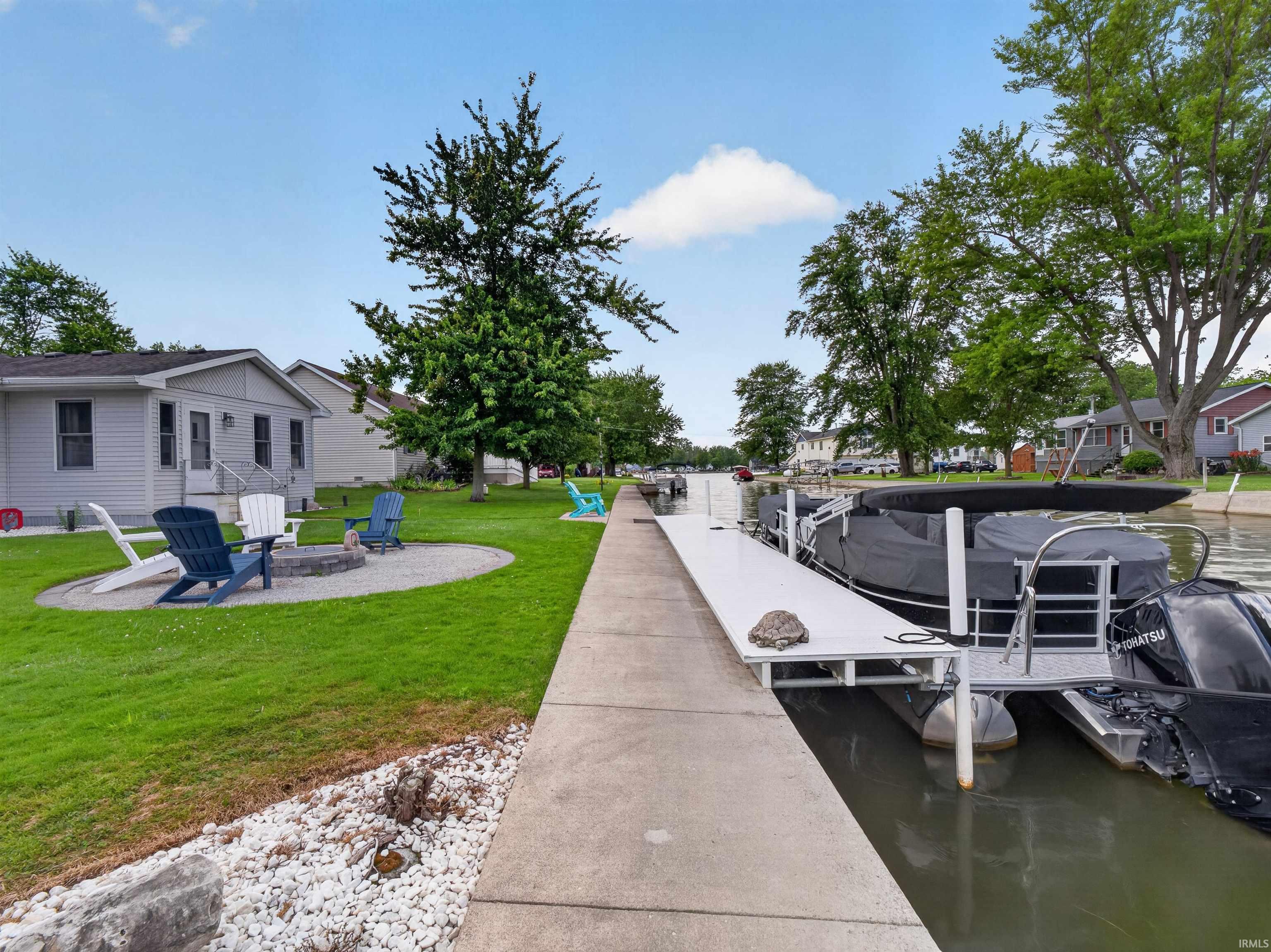Private dock and waterside access featuring a concrete walkway