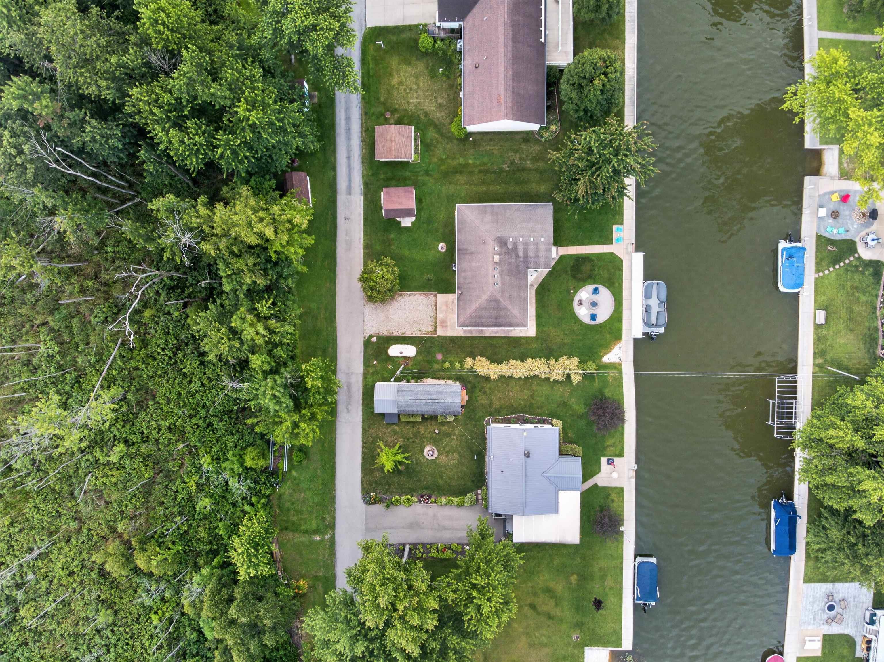 Waterfront property featuring direct canal access, private boat slips, and multiple structures