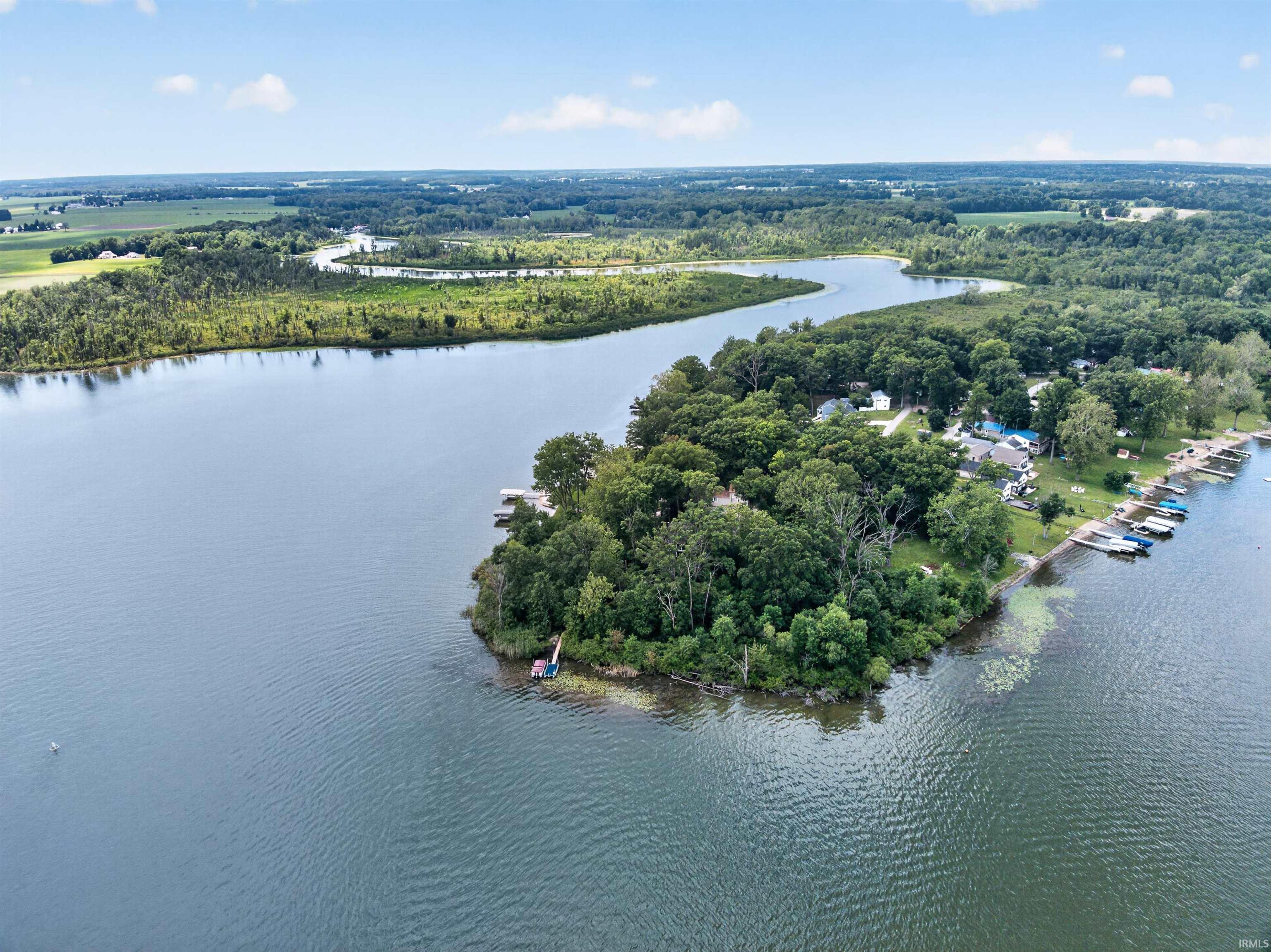 Expansive waterfront property with a dense tree line and multiple boat docks