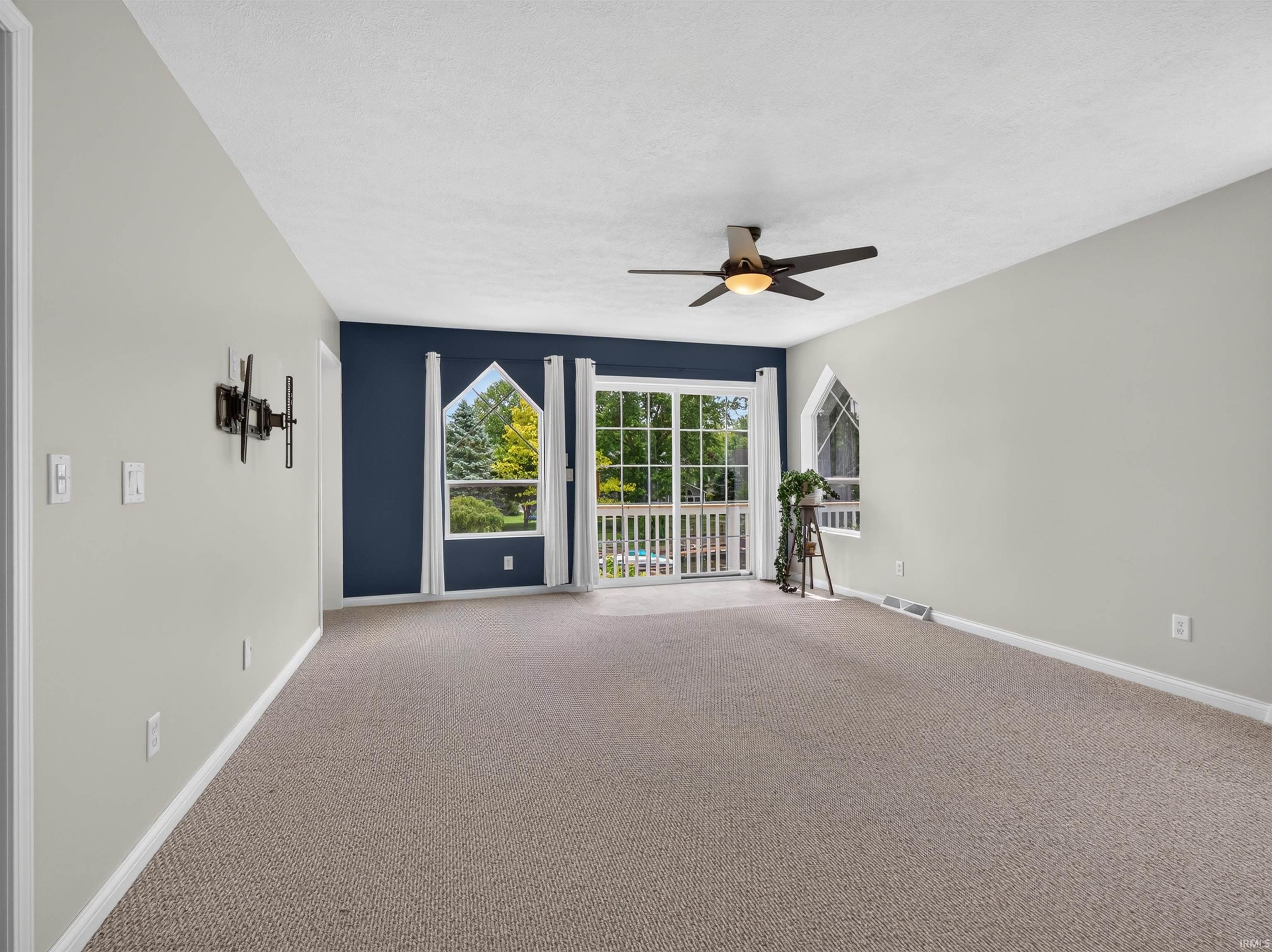 Expansive room featuring carpet flooring and light gray walls