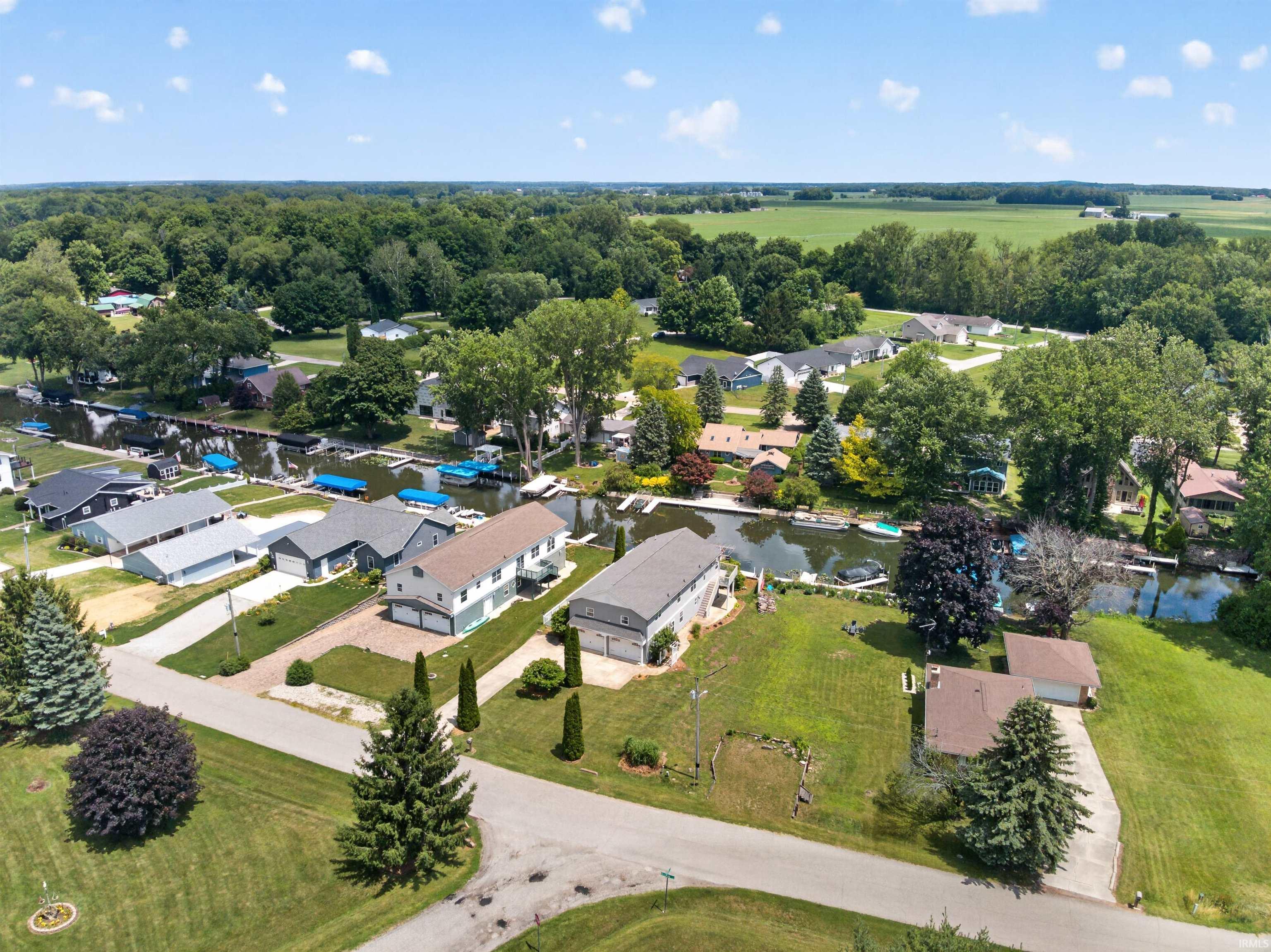 Waterfront community featuring canal access, private boat docks, mature trees, and surrounding green spaces