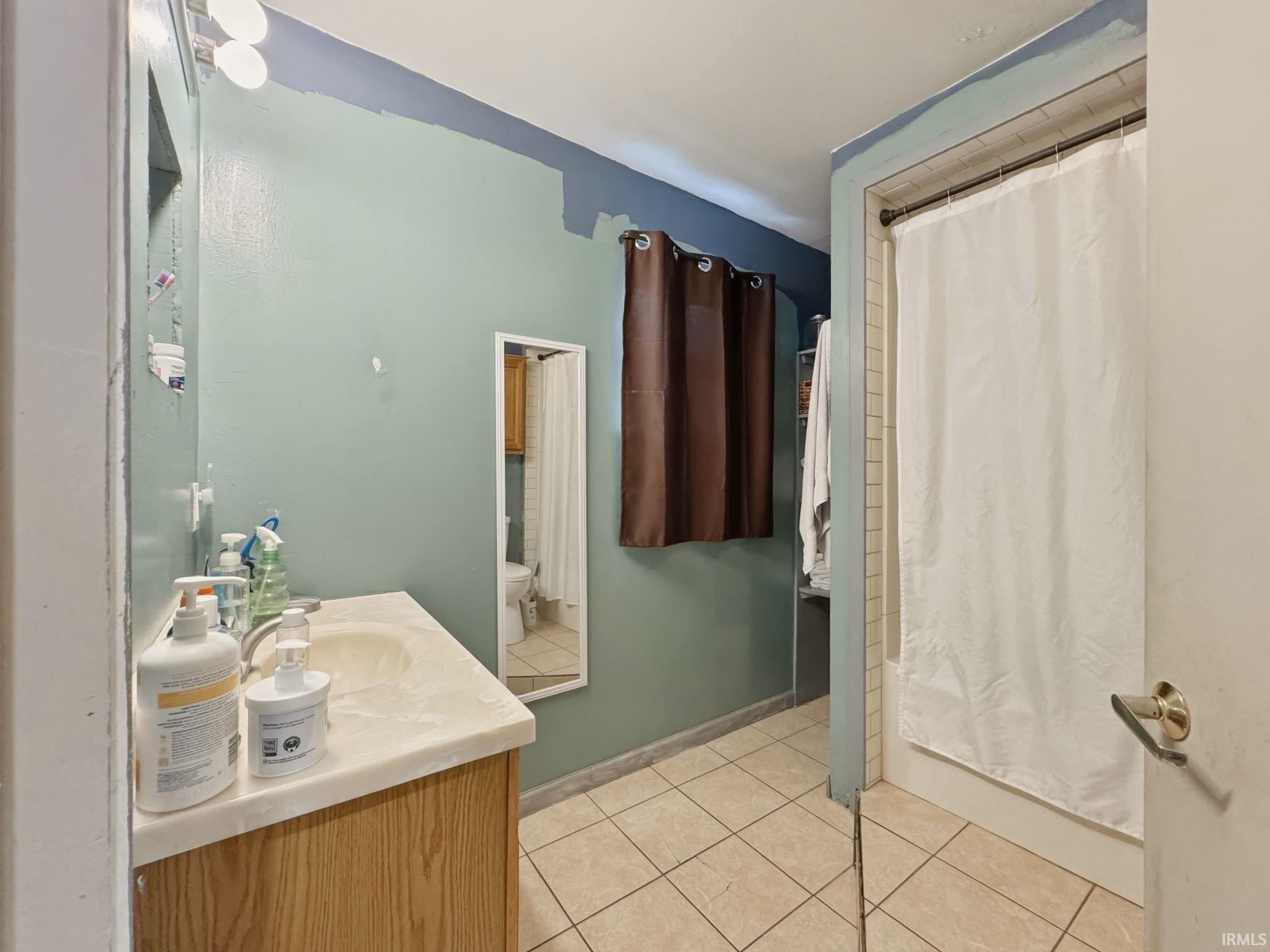 Bathroom vanity with integrated sink and wood-finish cabinetry