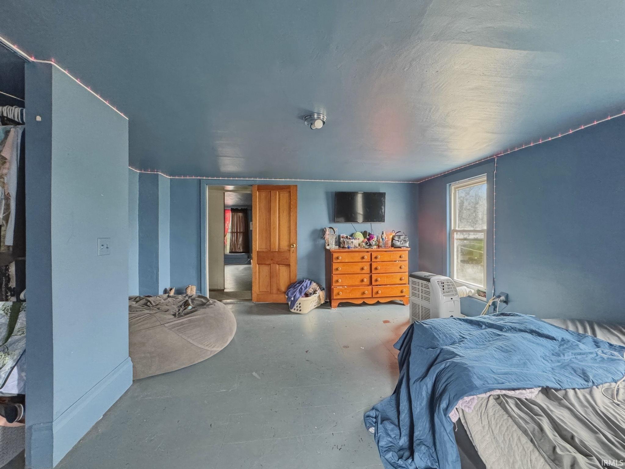Room featuring painted walls, painted flooring, and a single window with natural light