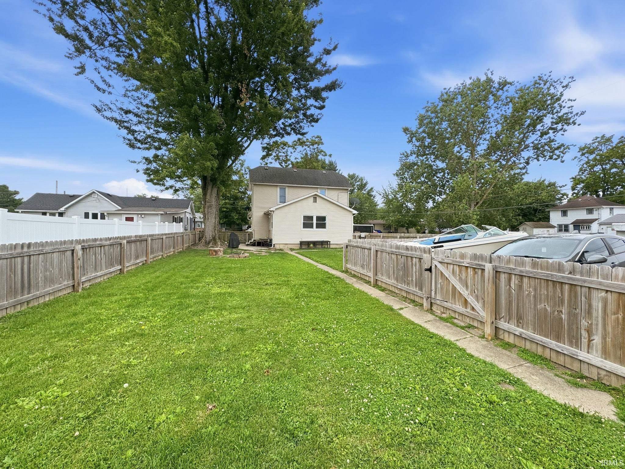 Expansive grassy yard with mature trees