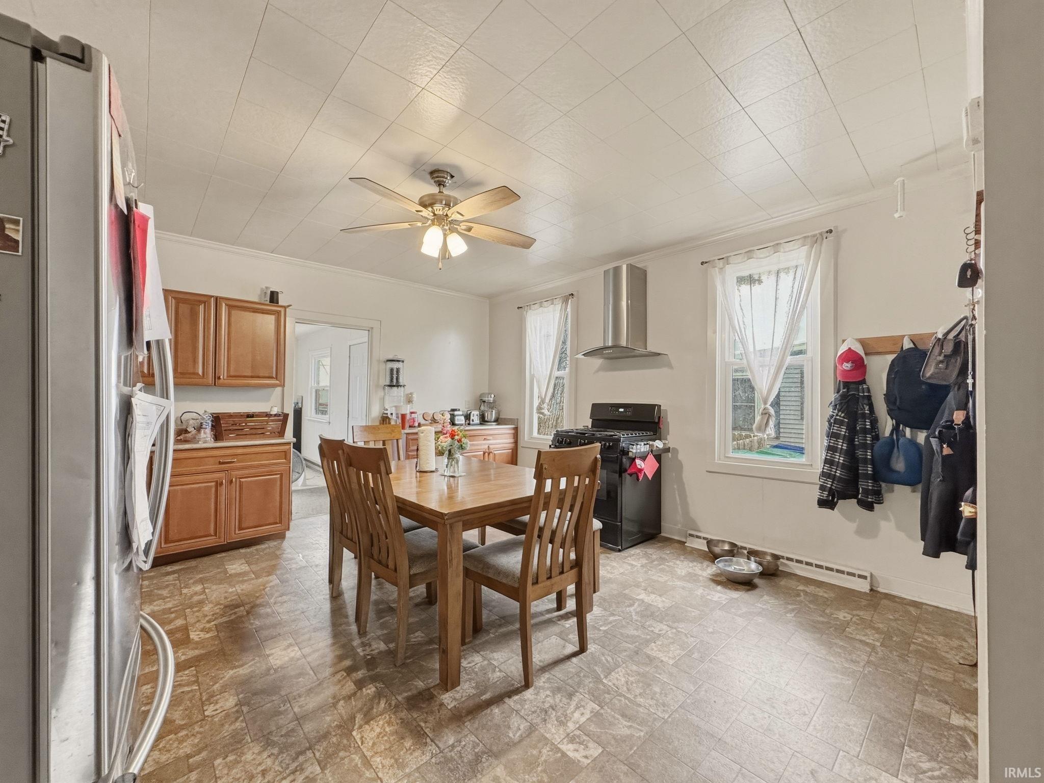 Spacious kitchen featuring a ceiling fan, recessed lighting, and ample natural light from multiple windows