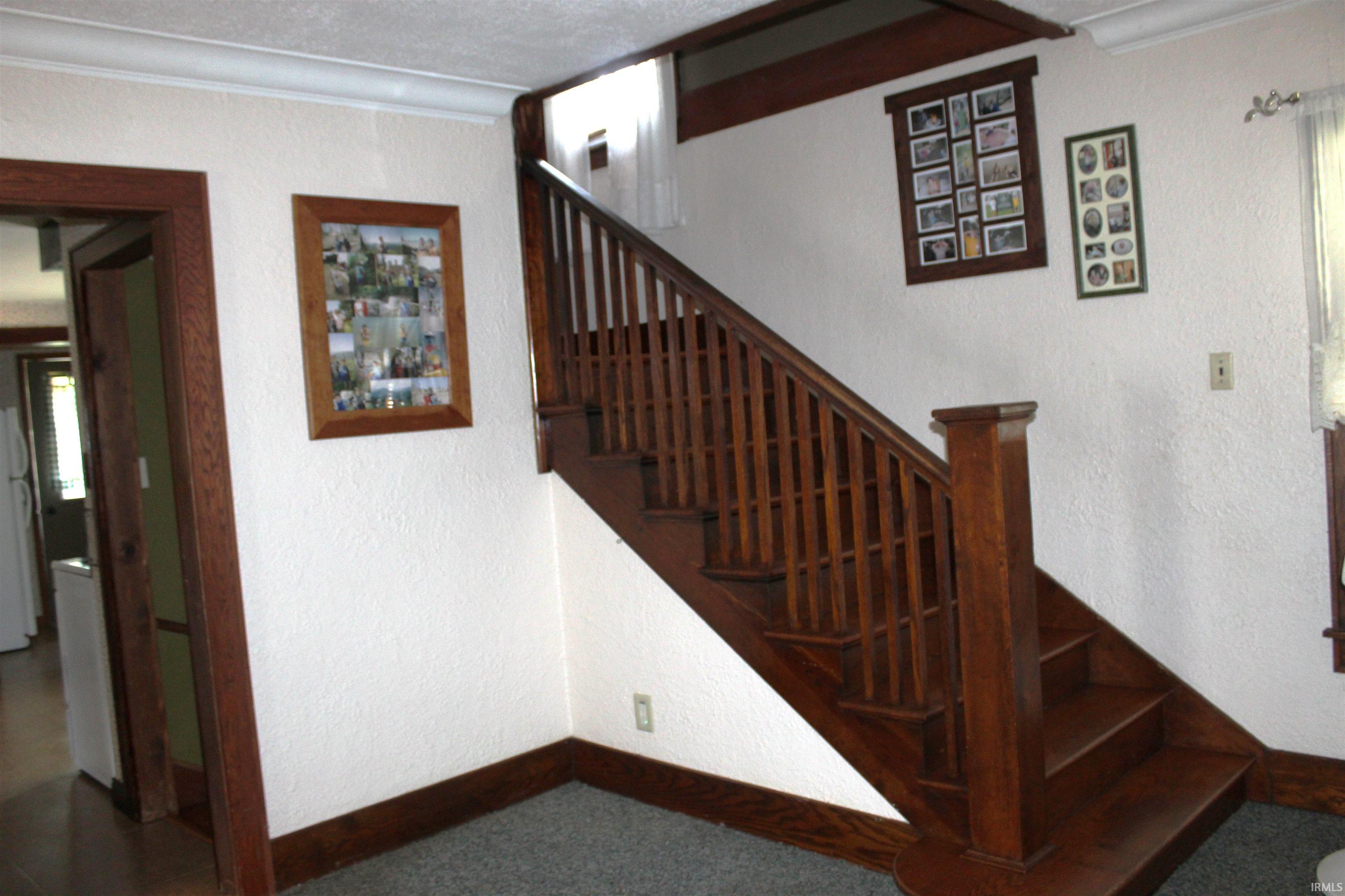 Hardwood staircase with baluster railing and newel post
