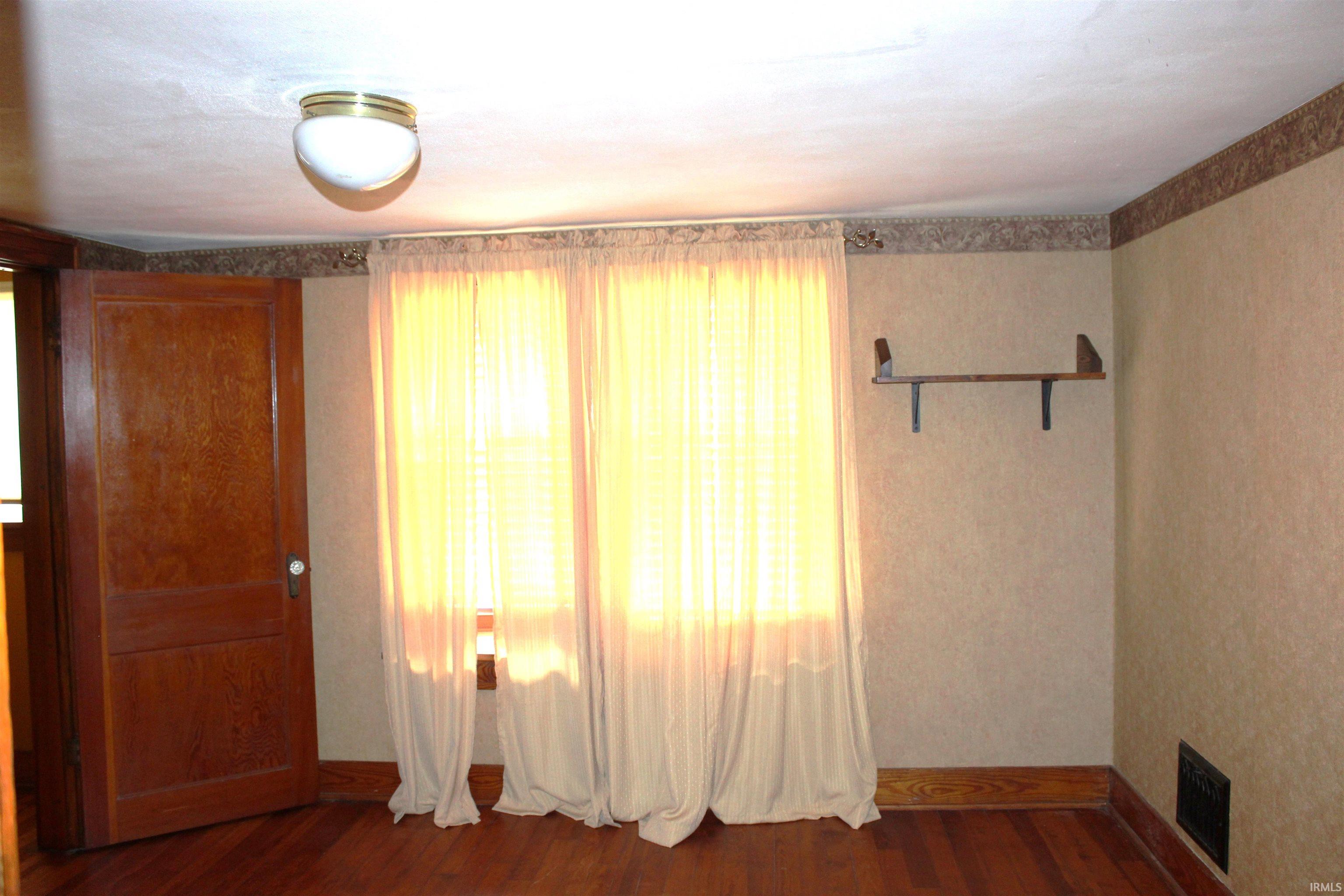 Hardwood-finish flooring with coordinating wood trim and baseboards
