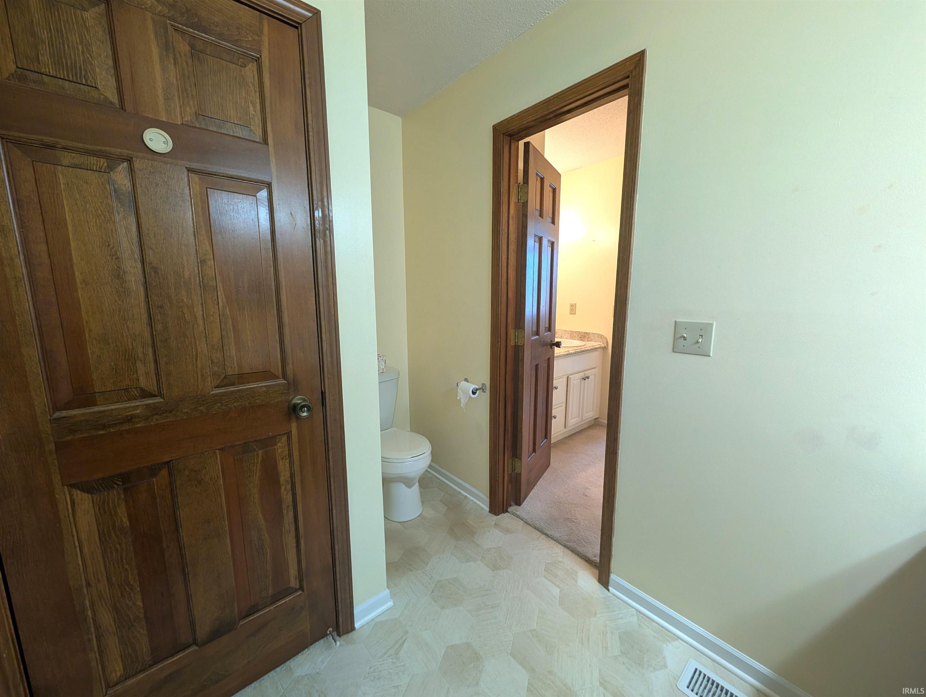 Wood-paneled doors with circular hardware