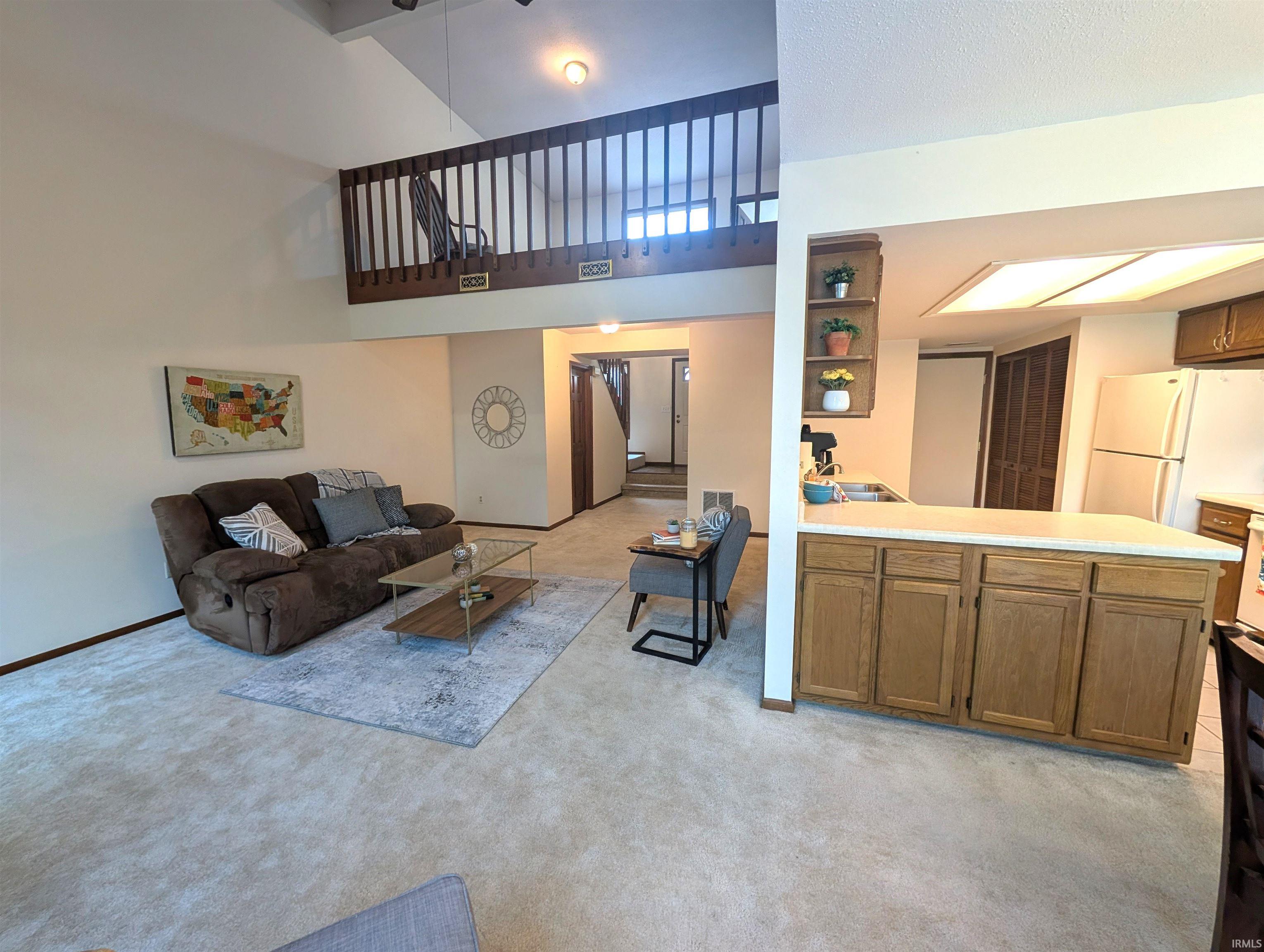 Vaulted living space featuring an open-concept layout with a second-story loft overlooking the main area