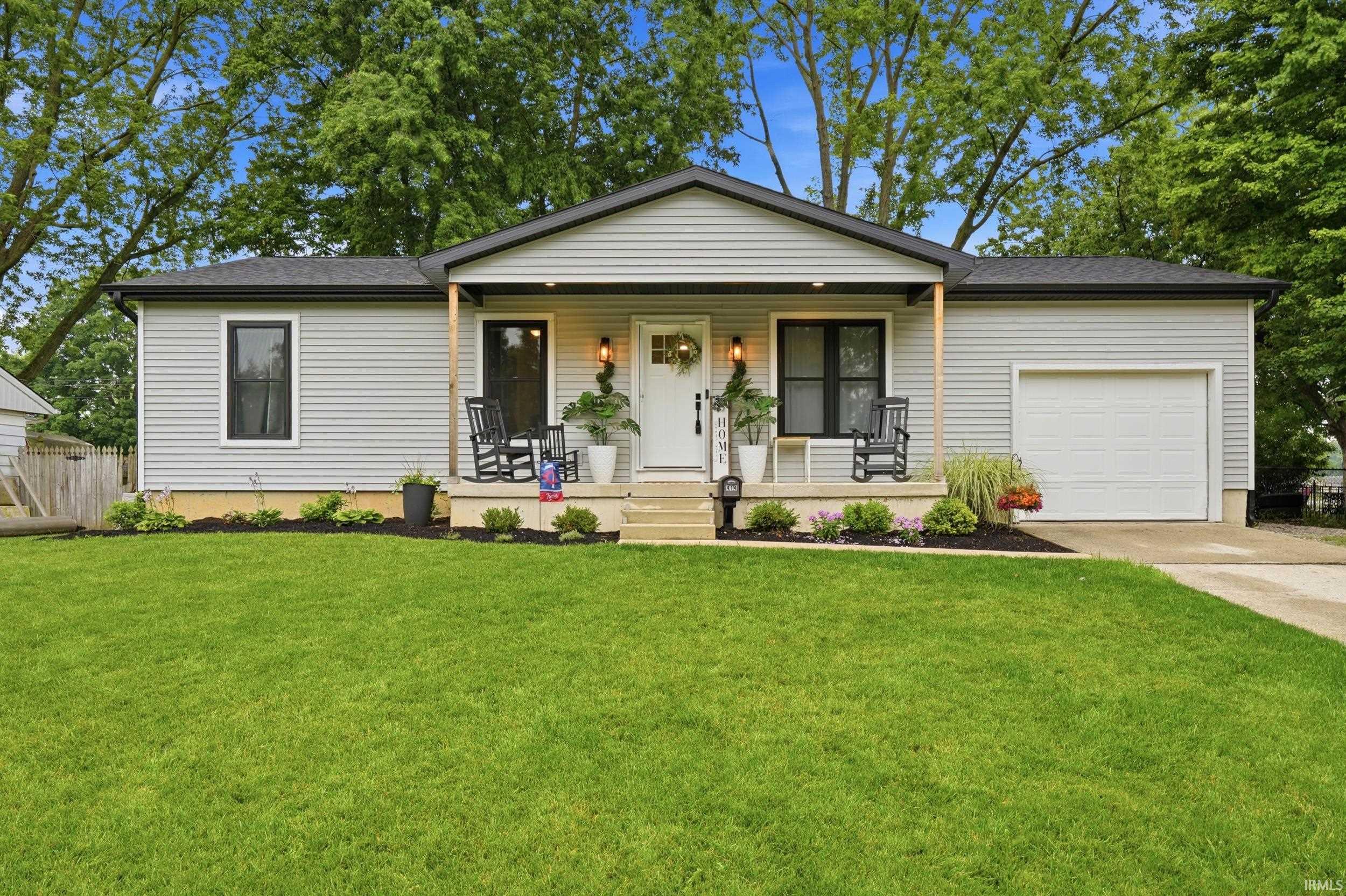 Light gray siding exterior with a contrasting black roof