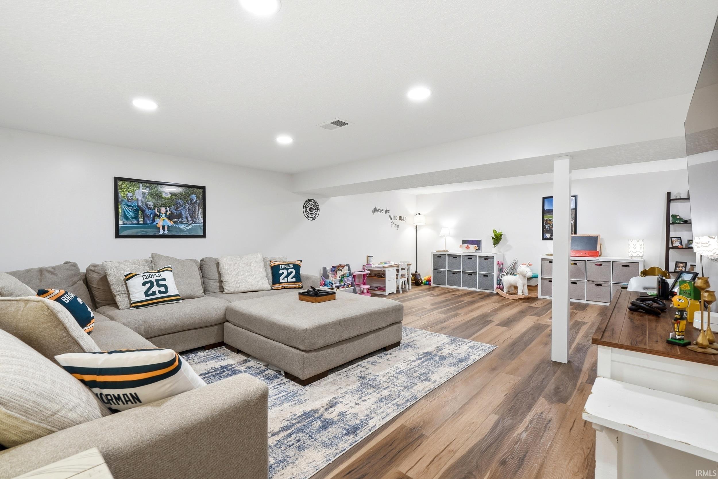 Spacious lower level featuring wood-finish flooring, recessed lighting, and a neutral color palette