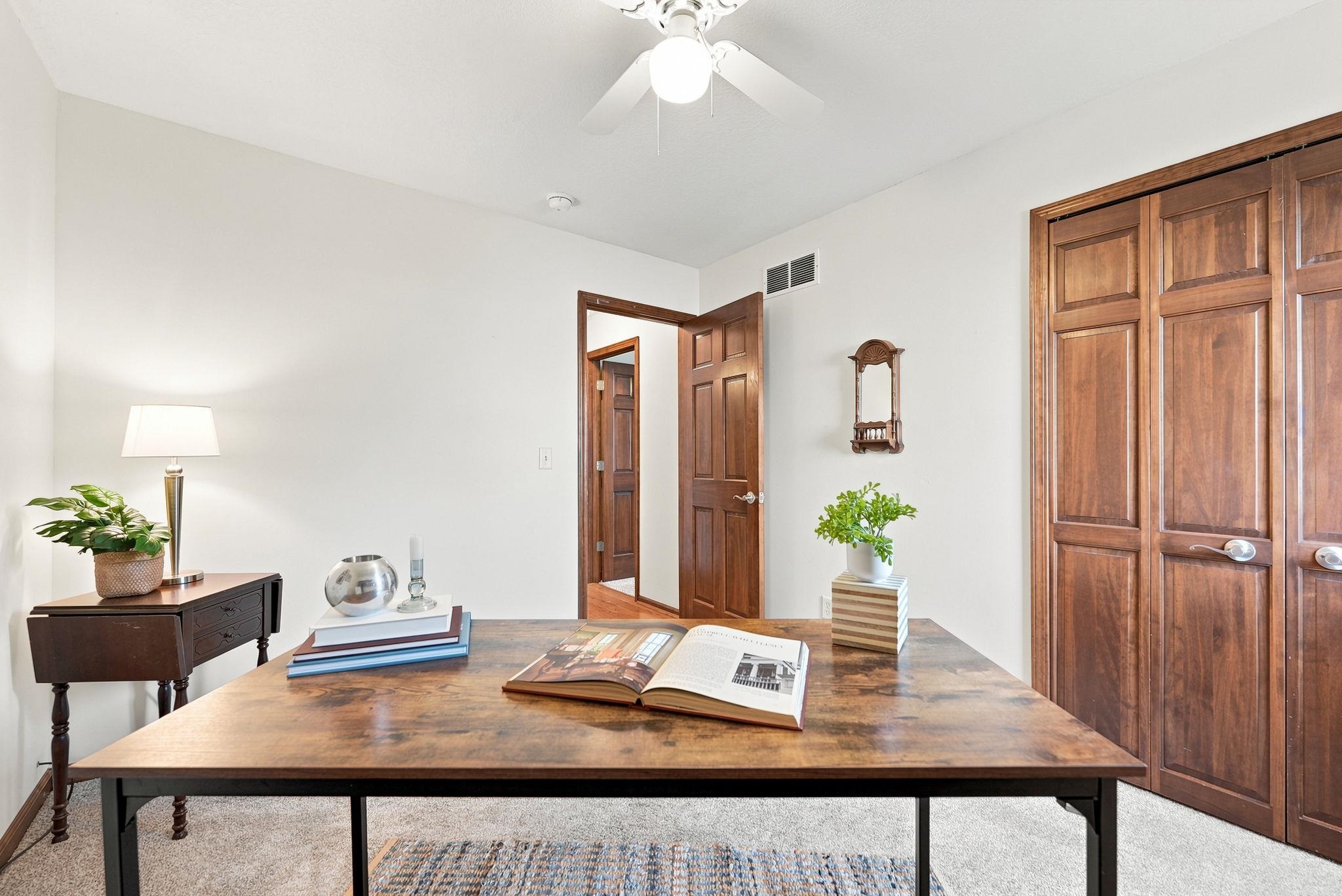 Neutral wall paint, vaulted ceiling, and recessed lighting