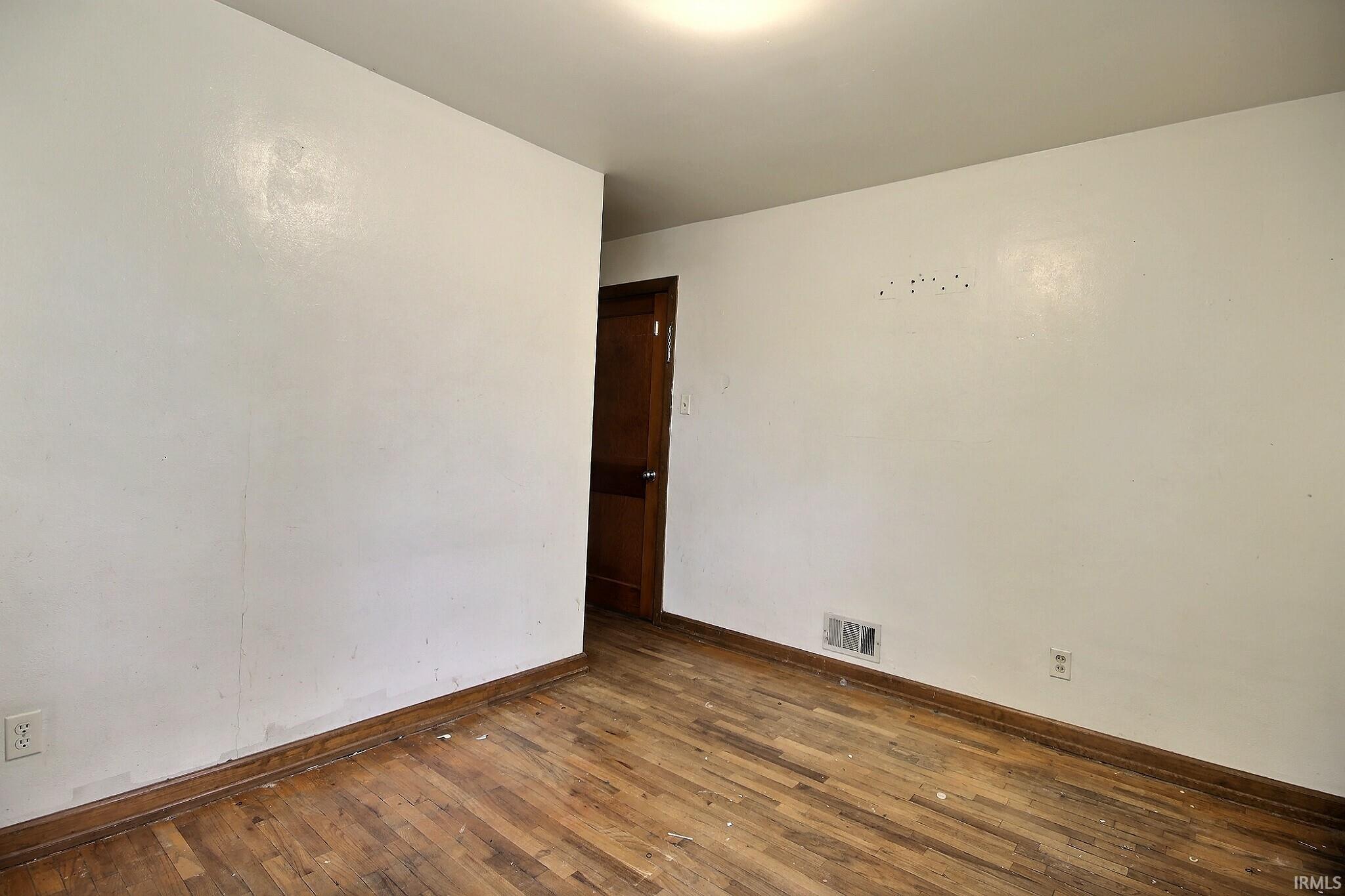 Hardwood-finish flooring with wood baseboards and trim