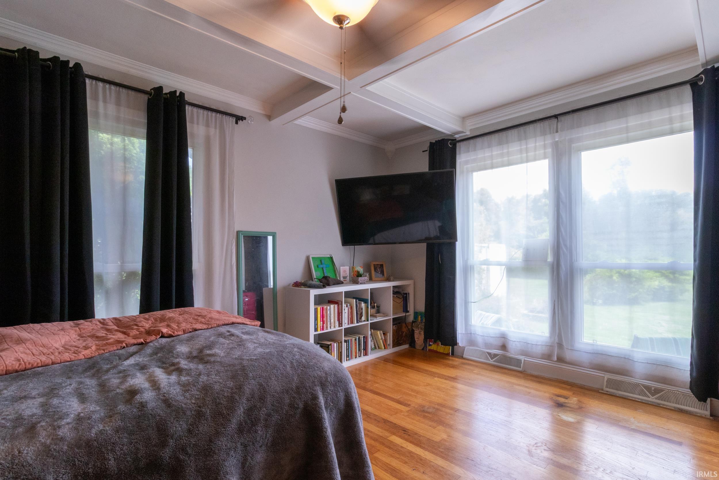 Hardwood flooring complemented by coffered ceilings