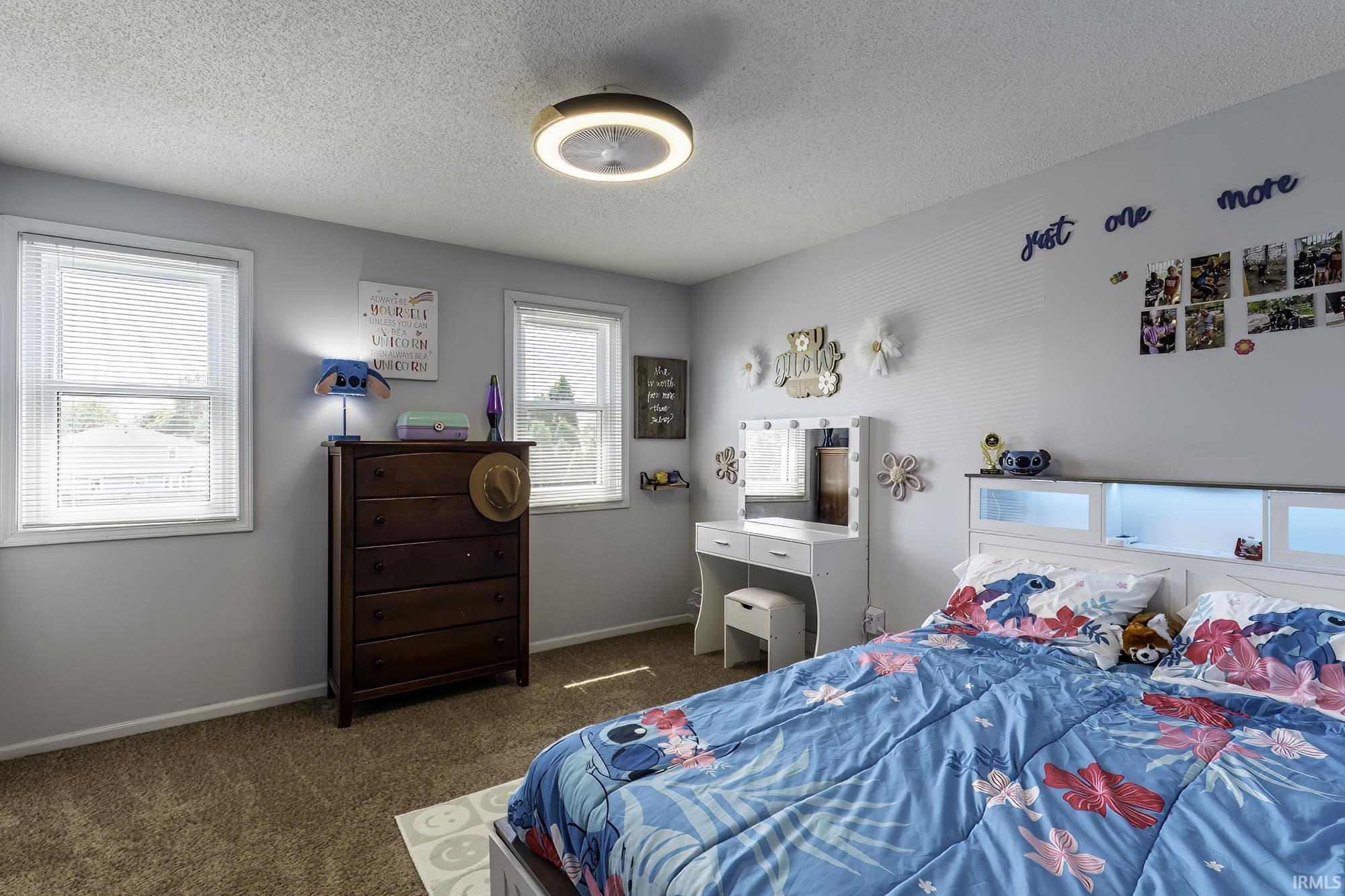Plush carpeted flooring complements light gray wall tones