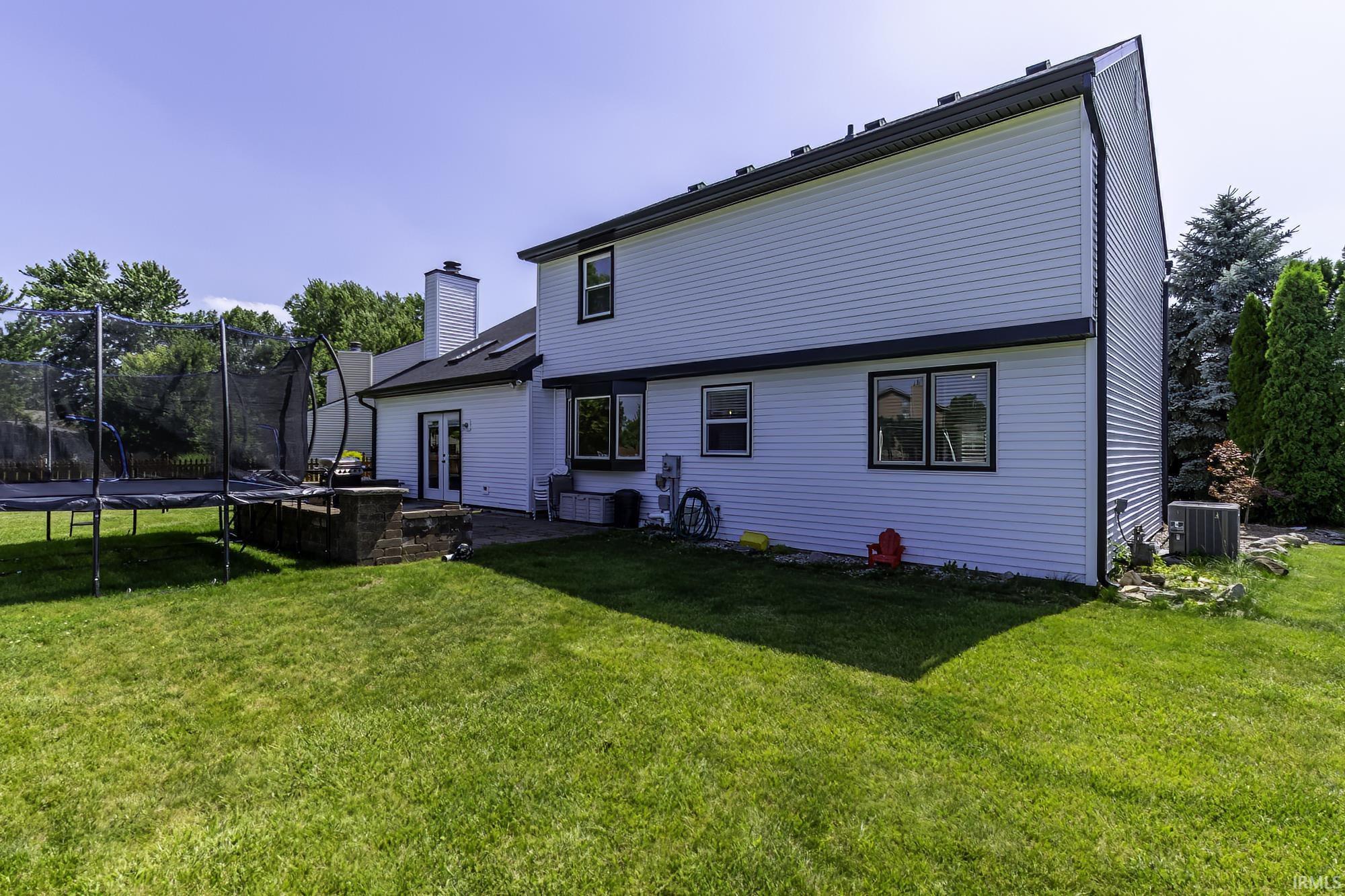 Spacious rear yard with a stone paver patio