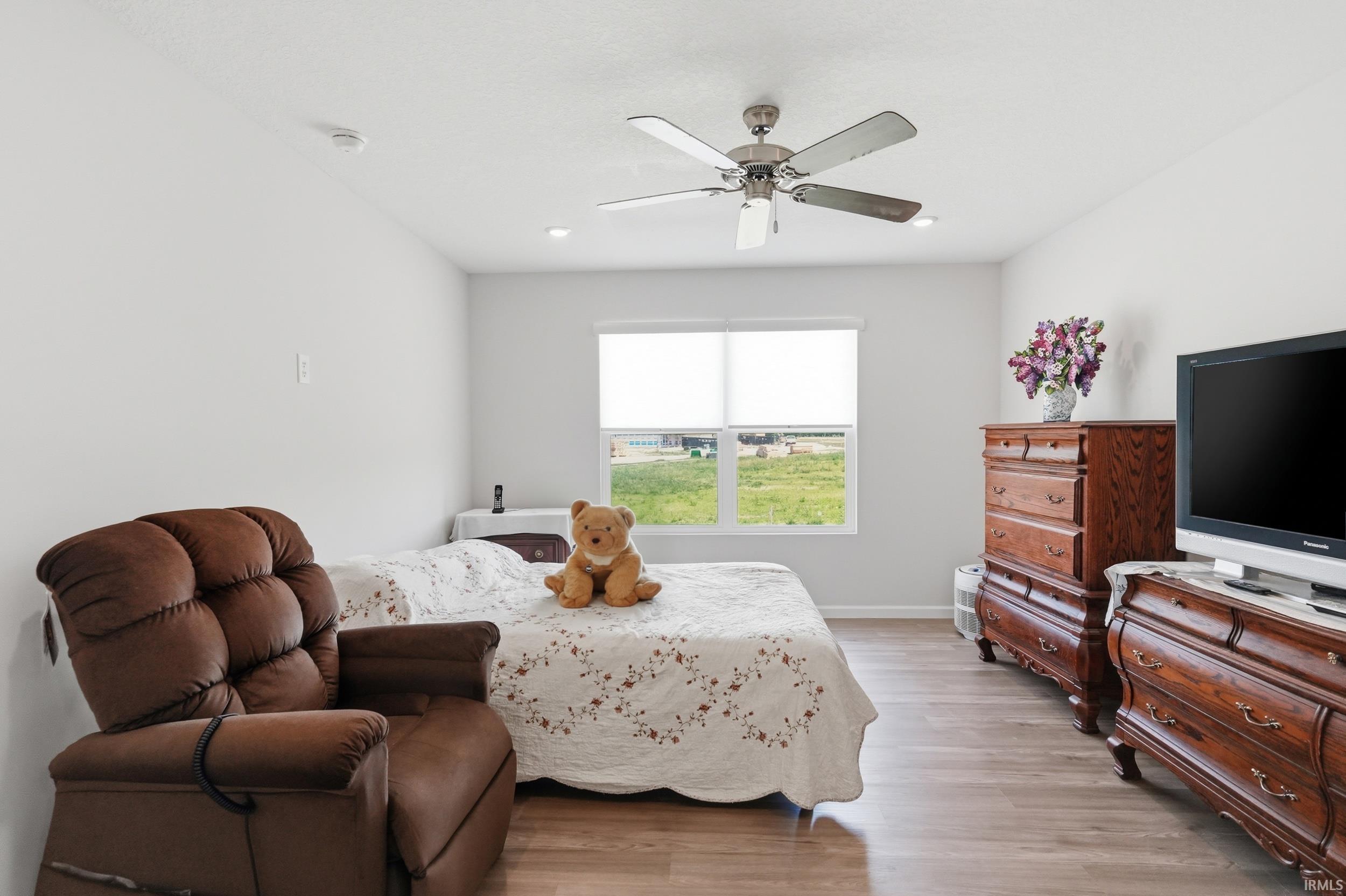 Bright interior space featuring light-toned walls and wood-finish flooring