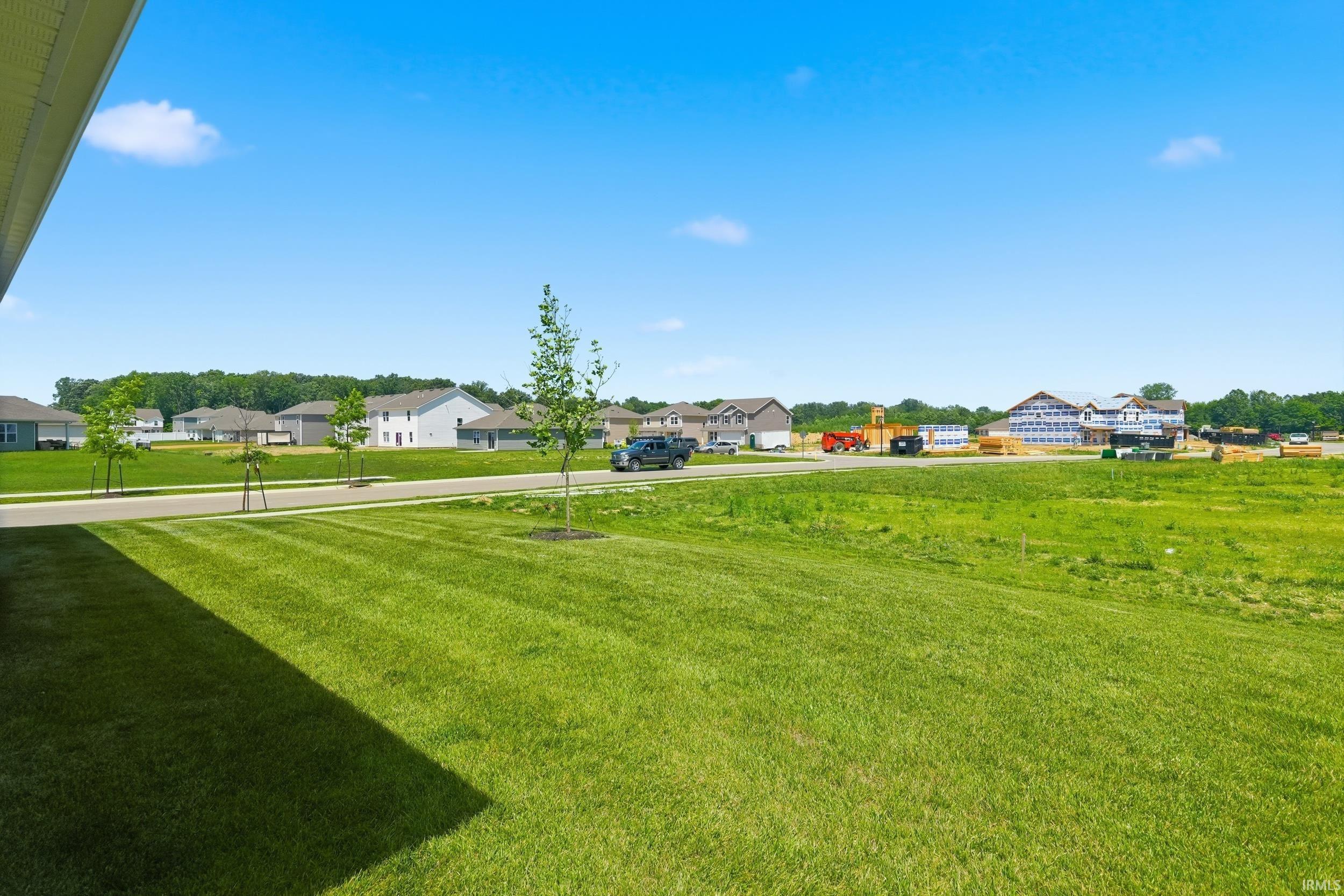 Expansive green lawn extending from a covered patio area