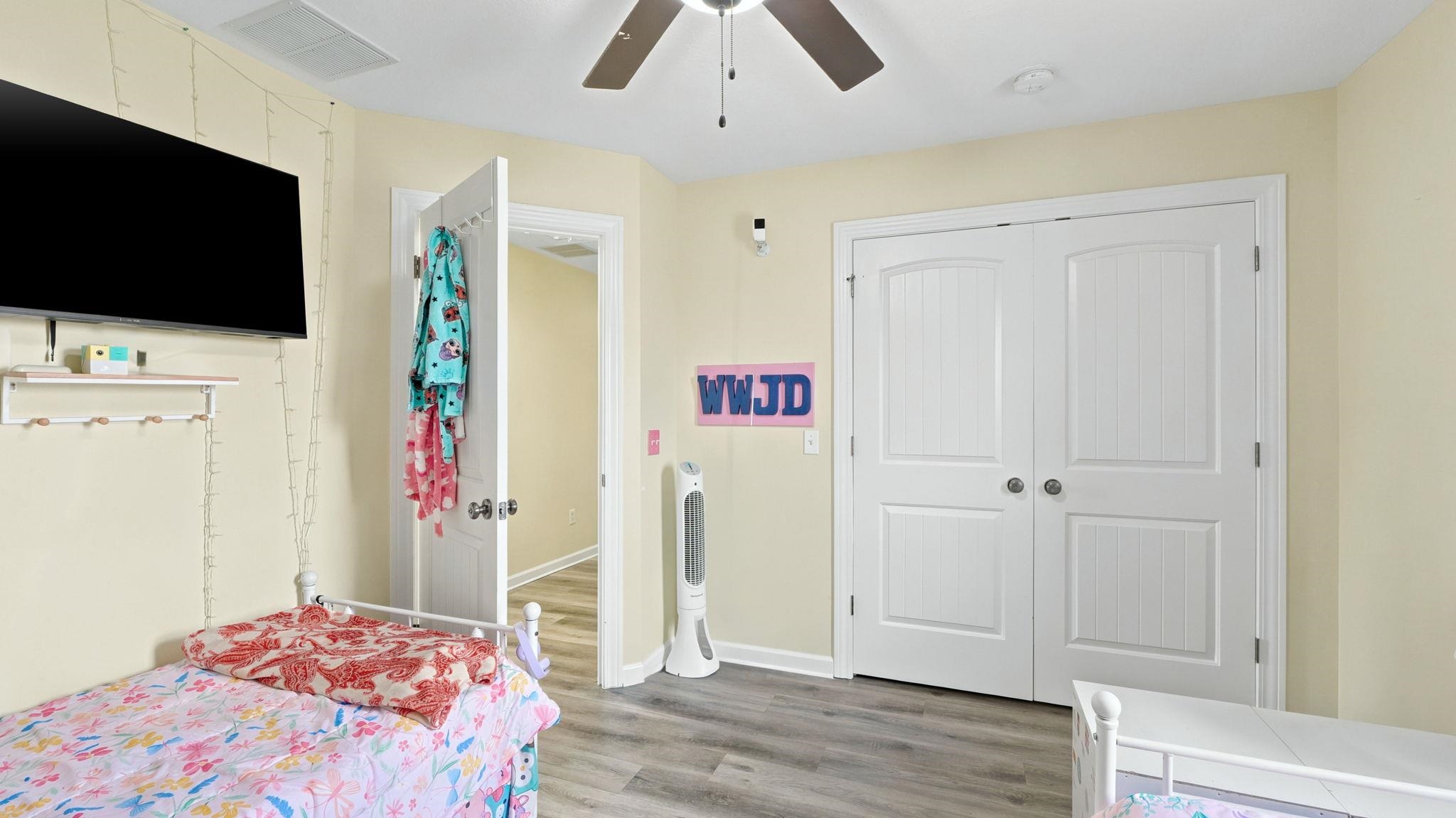 Neutral wall tones with wood-finish flooring provide a versatile base