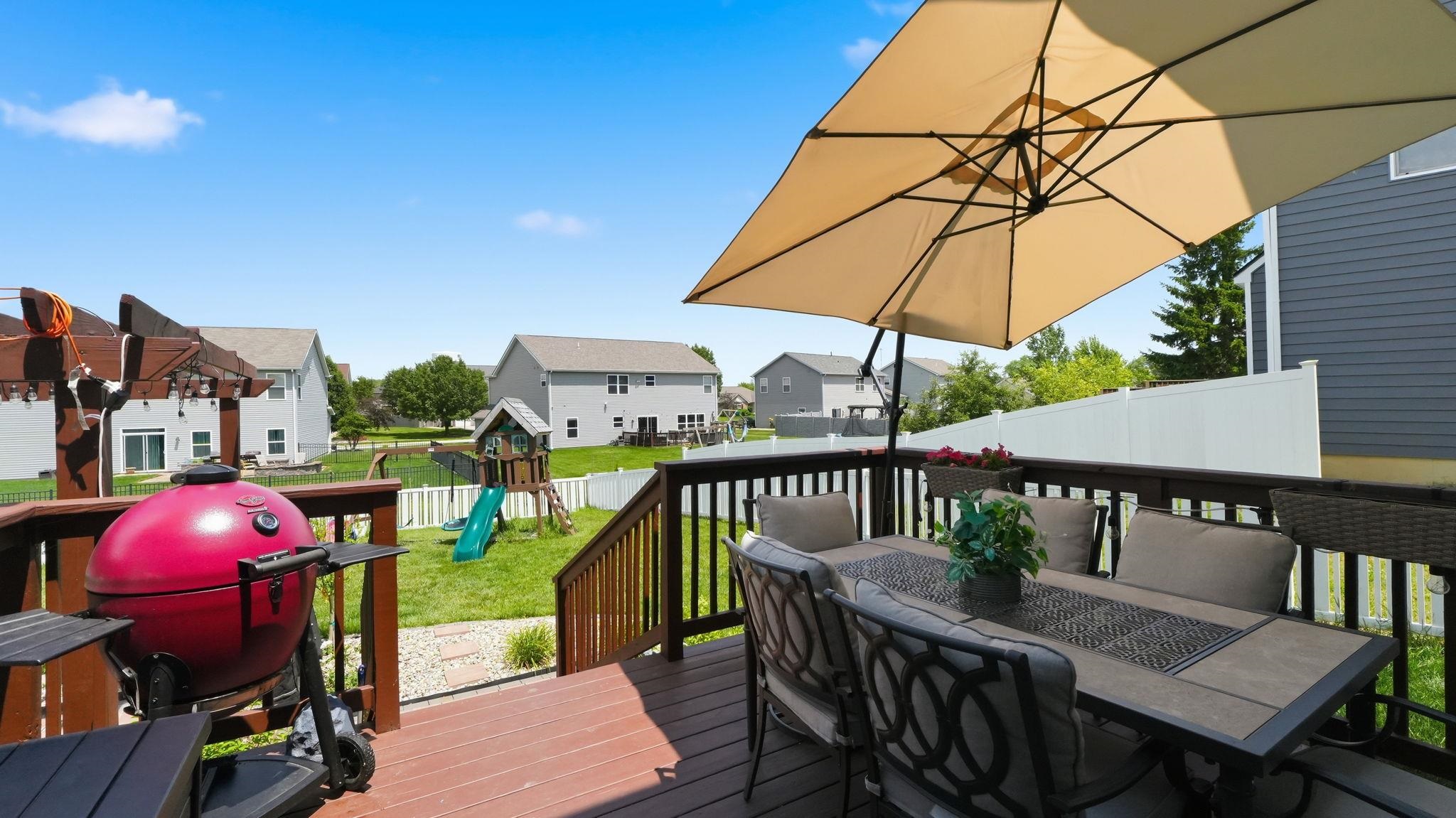 Spacious outdoor deck featuring rich wood-finish decking and railings