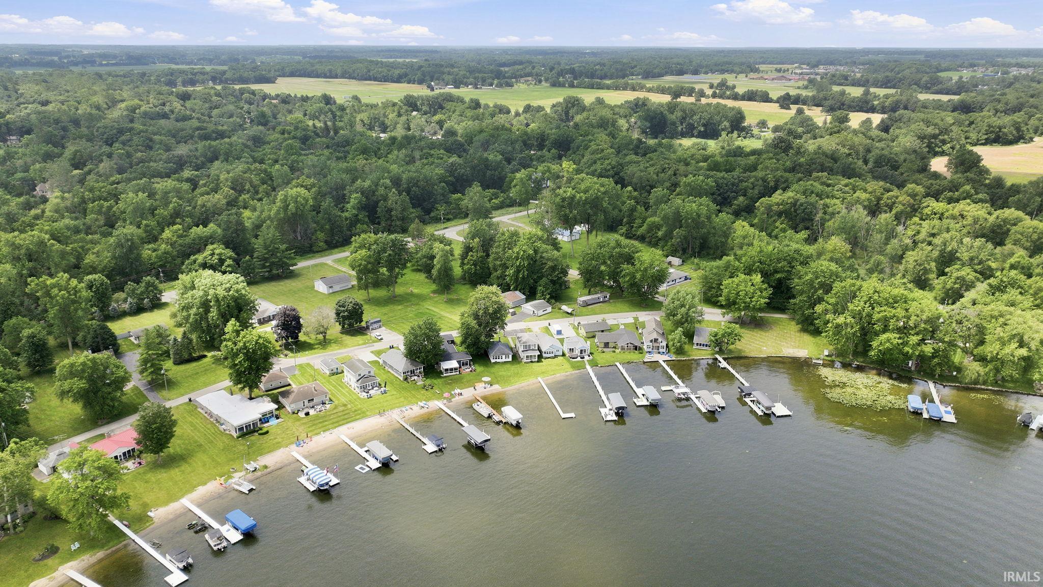 Waterfront properties featuring private docks and grassy shorelines