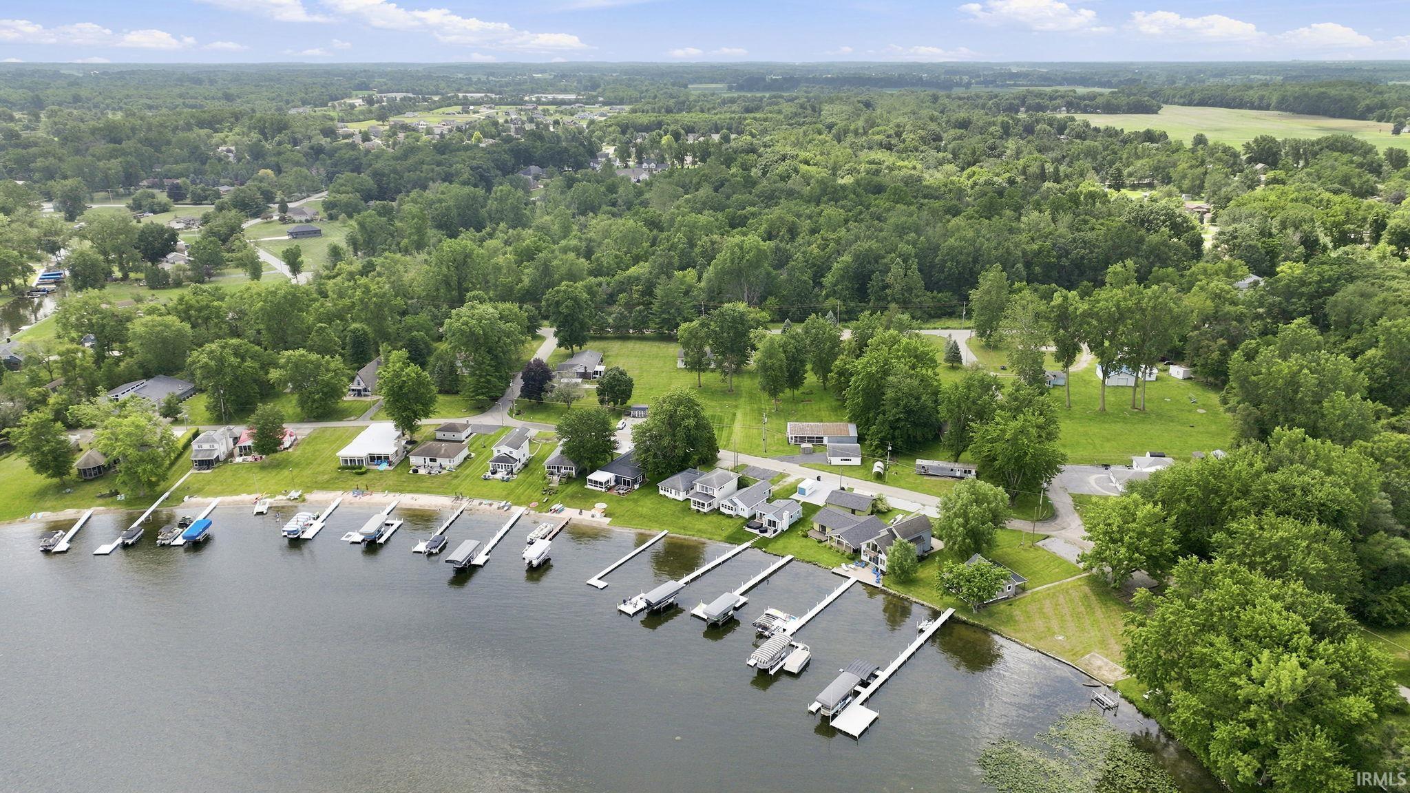 Waterfront properties featuring private boat docks and a lush, tree-lined landscape