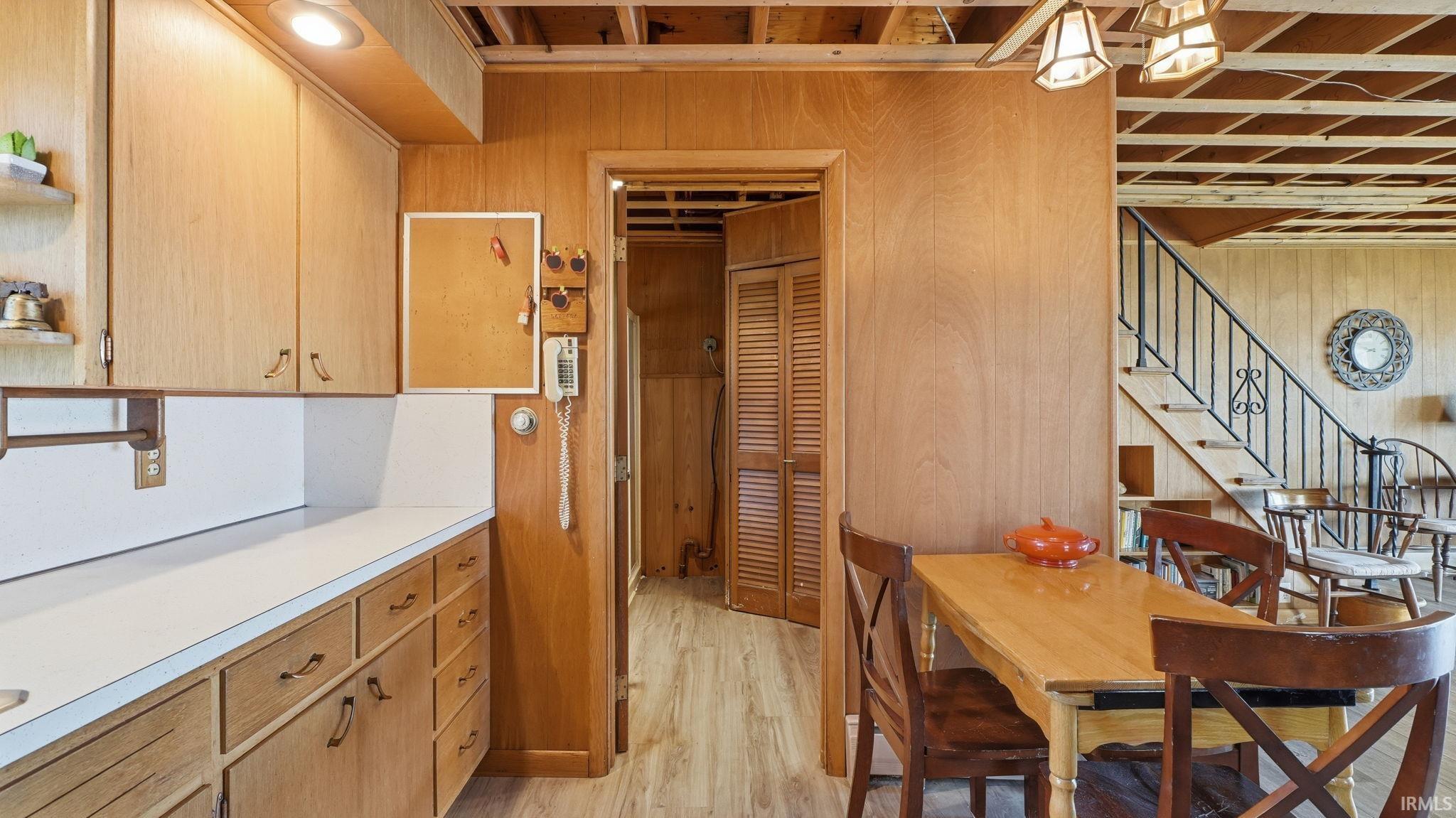 Kitchen area featuring wood-finish cabinetry, white countertops, and recessed lighting