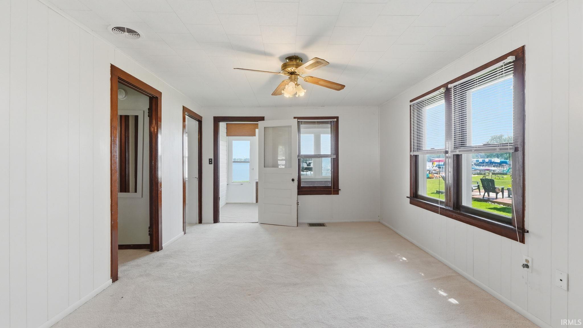 Interior space featuring light carpeting and white paneled walls