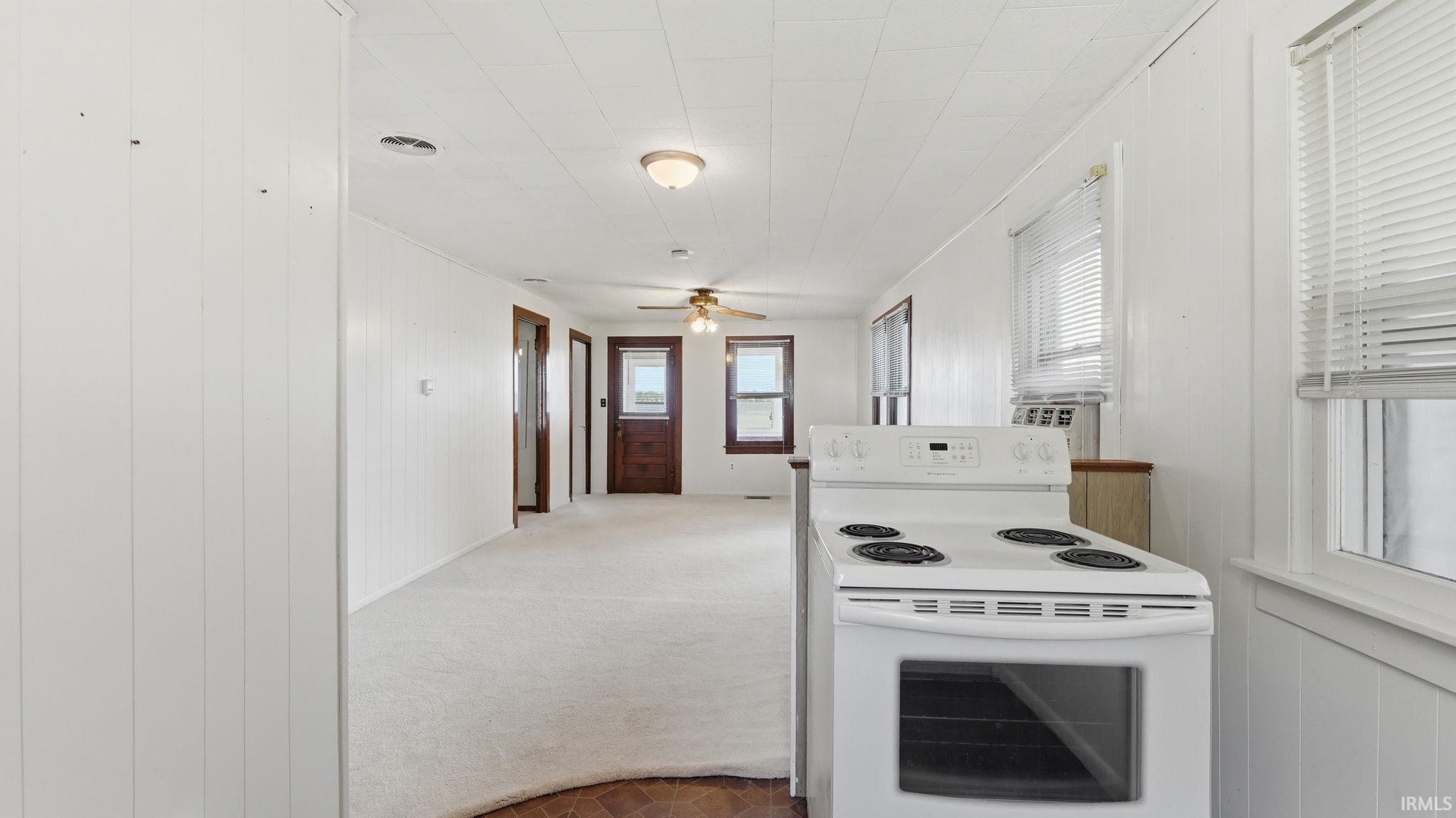 White paneling and light-colored carpeting throughout