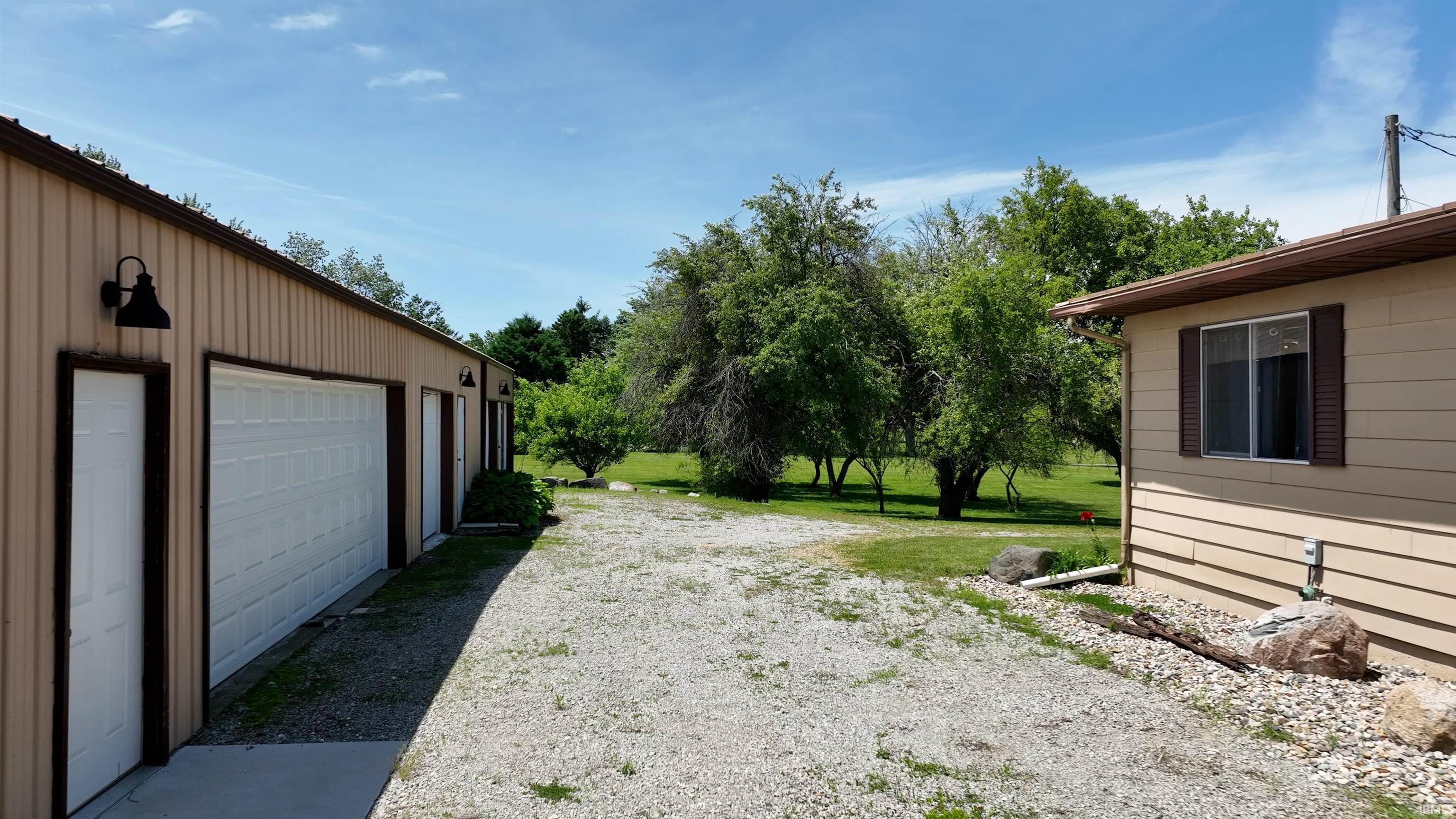 Large detached garage with multiple bays and exterior lighting