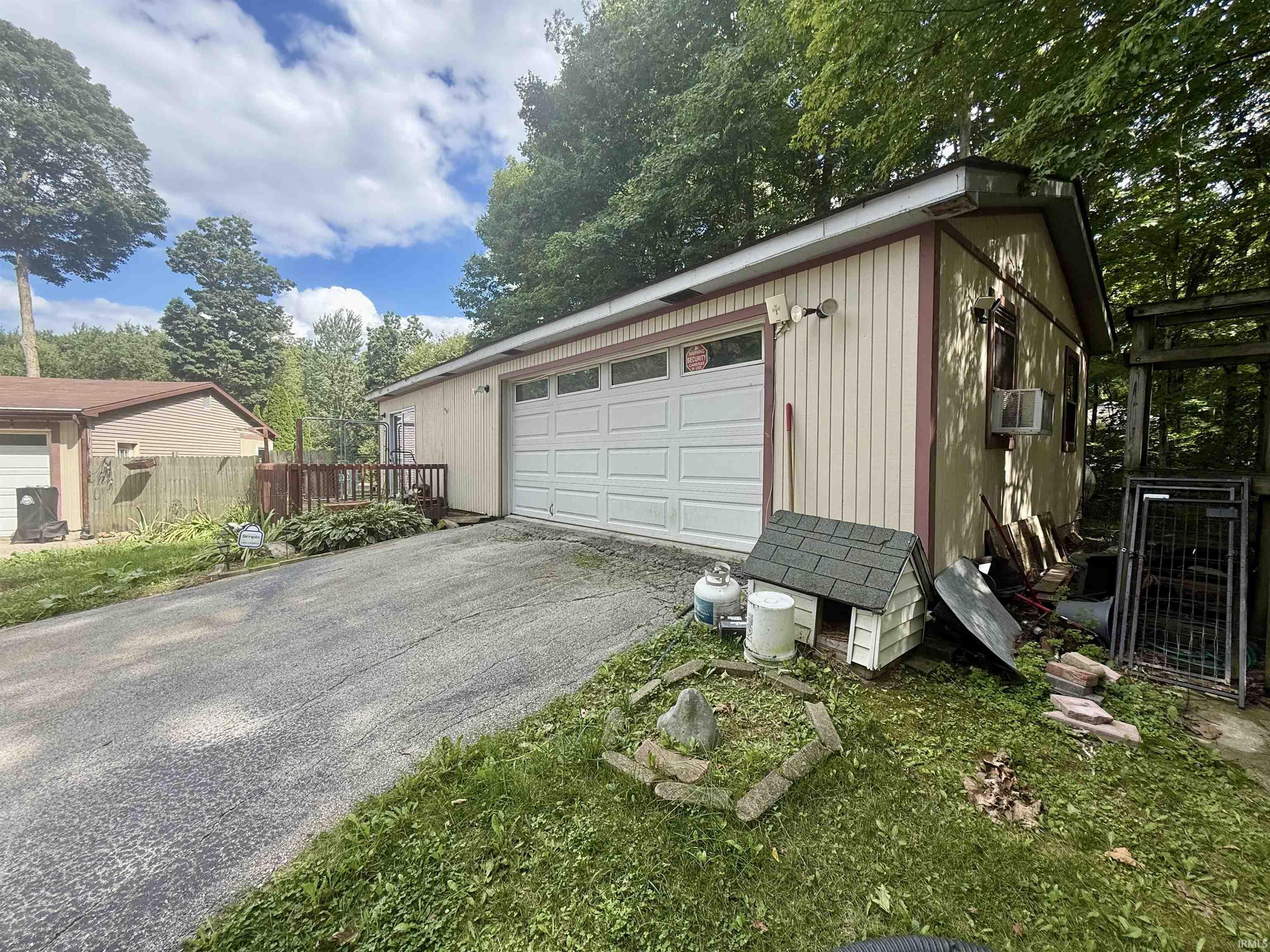 Two-car garage with white panel door and upper window accents