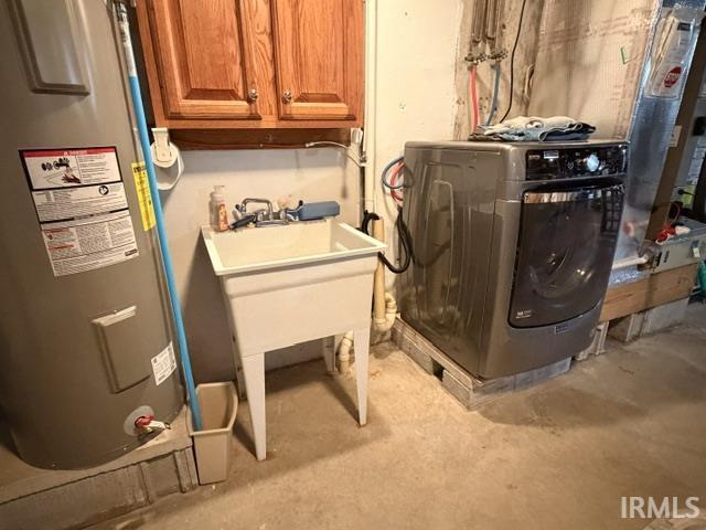 Laundry area with a utility sink, wood-finish cabinetry, and a water heater
