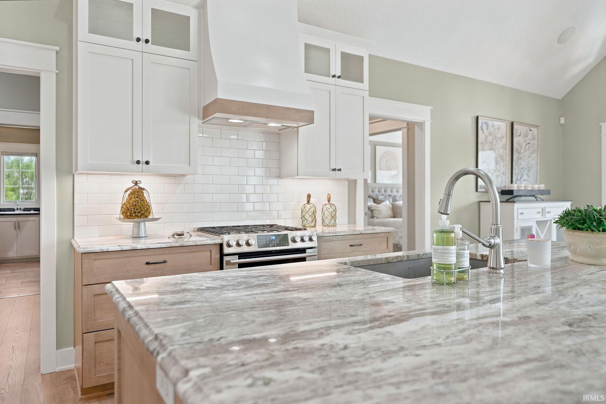 Kitchen featuring a large island with an undermount sink and gooseneck faucet