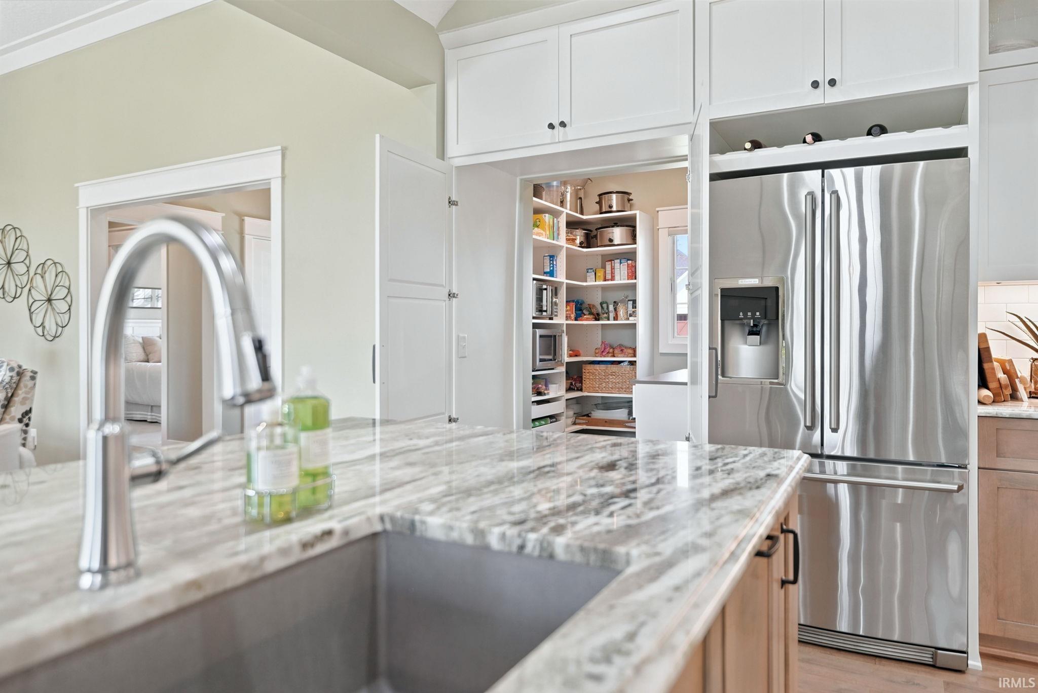 Kitchen island with a stainless steel sink and a polished chrome faucet