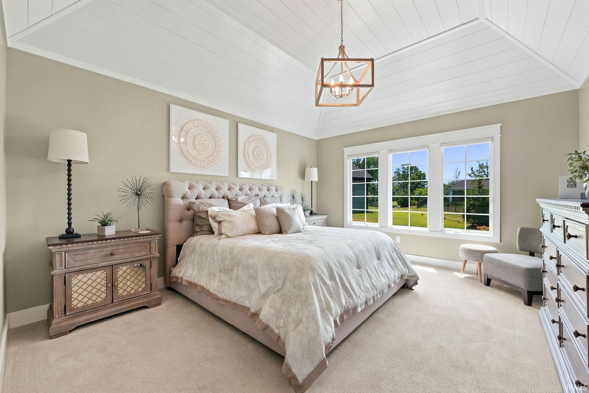 Tray ceiling with shiplap detailing and a modern open-frame chandelier