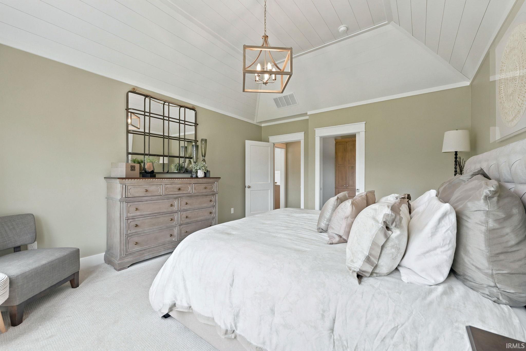 Vaulted shiplap ceiling with a geometric pendant light fixture