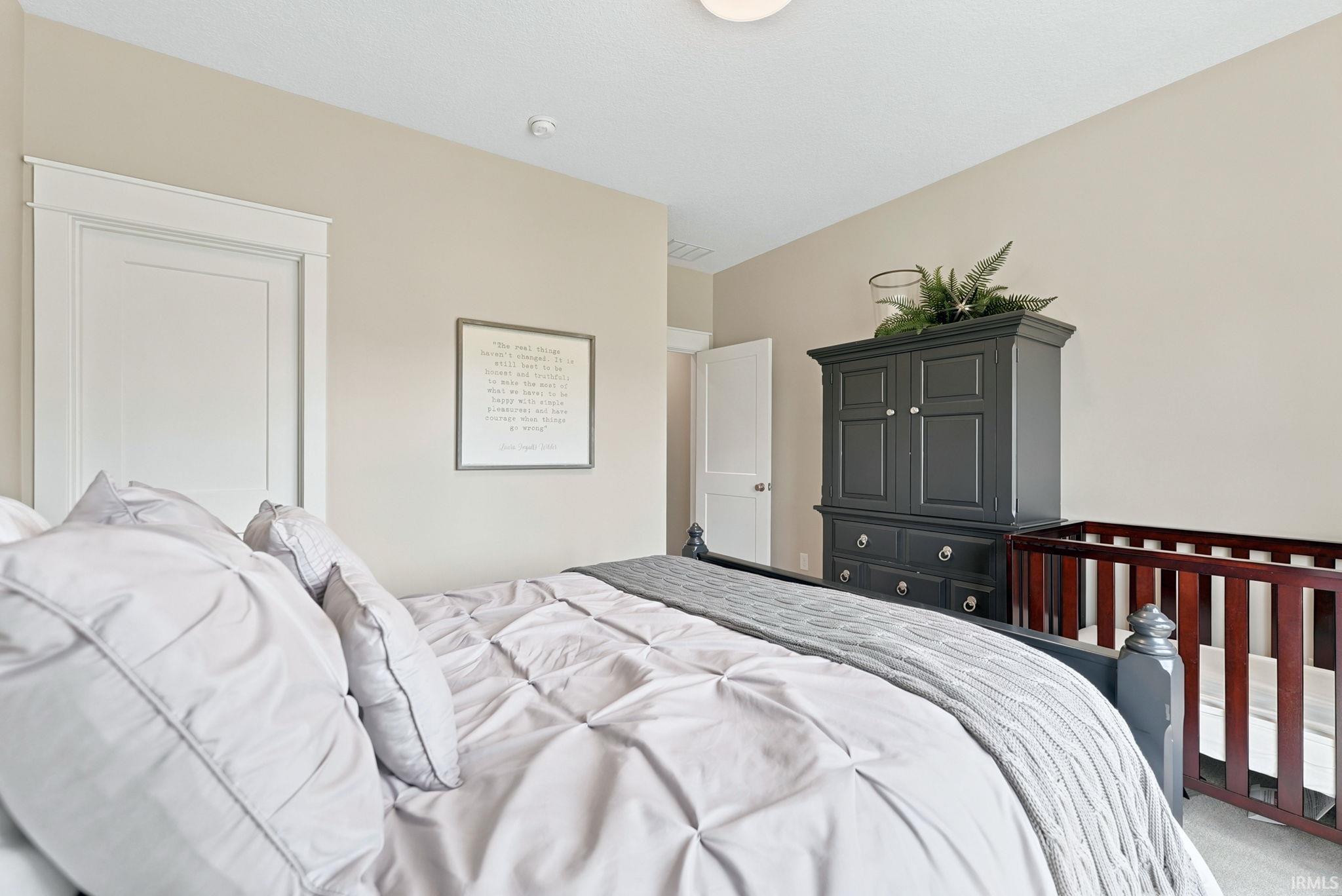 Neutral wall paint, white trim, and a white interior door define this room