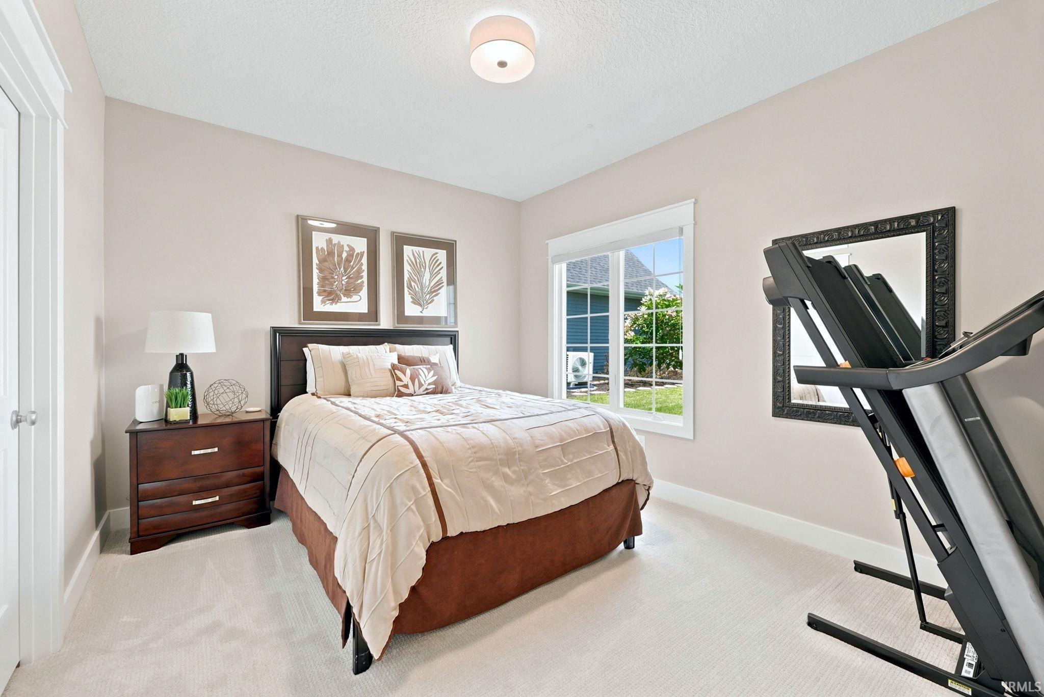 Neutral wall tones complement the light-toned carpet