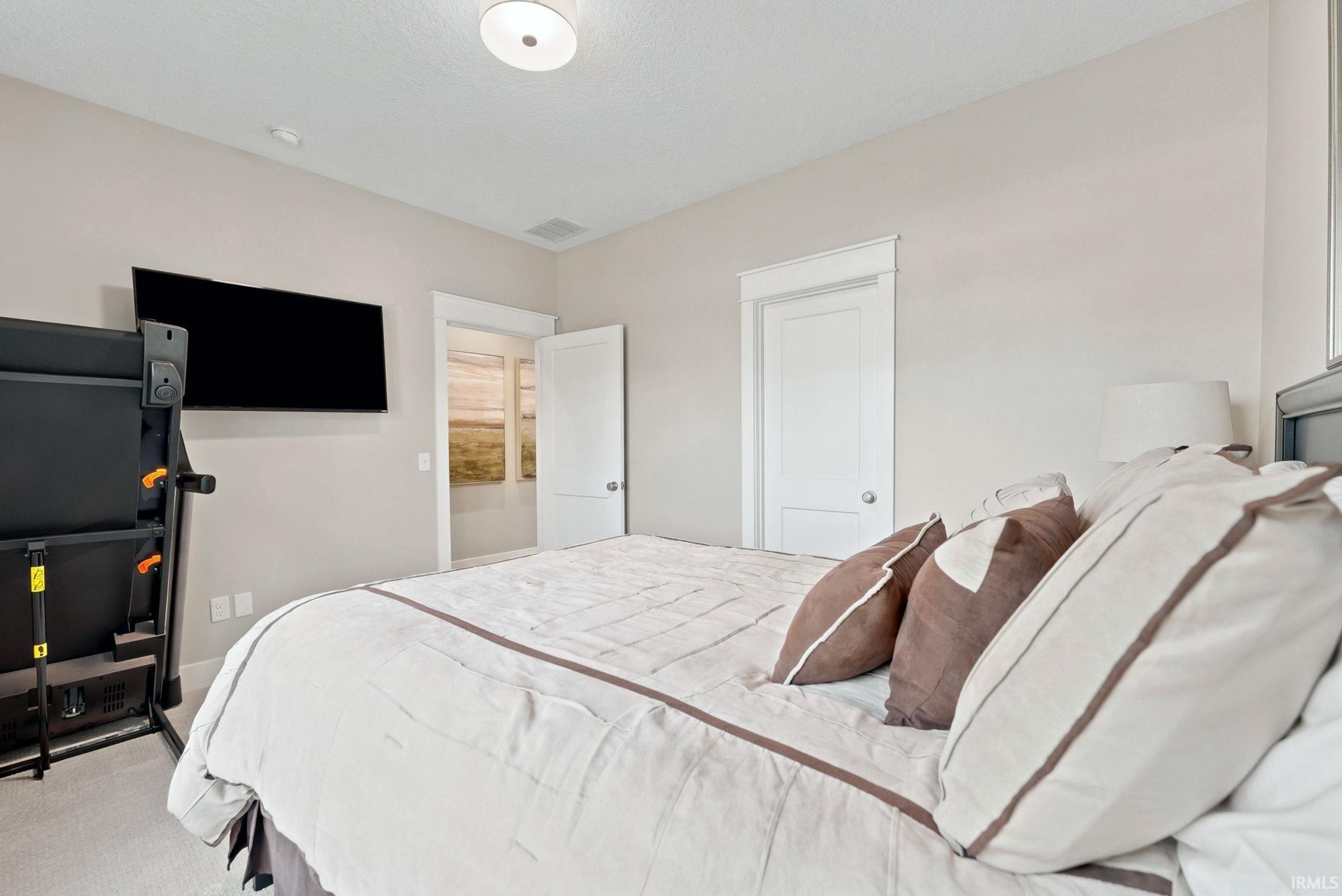 Carpeted interior space featuring a ceiling-mounted light fixture and recessed lighting