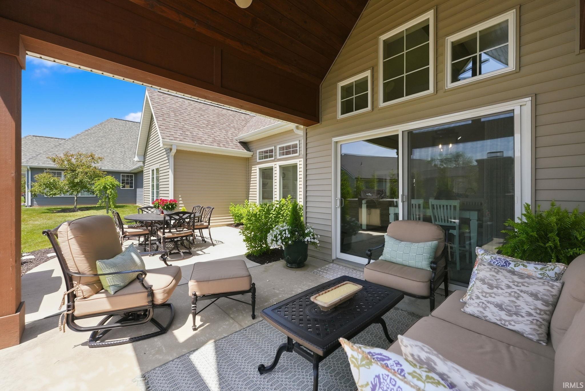 Covered outdoor patio with concrete flooring