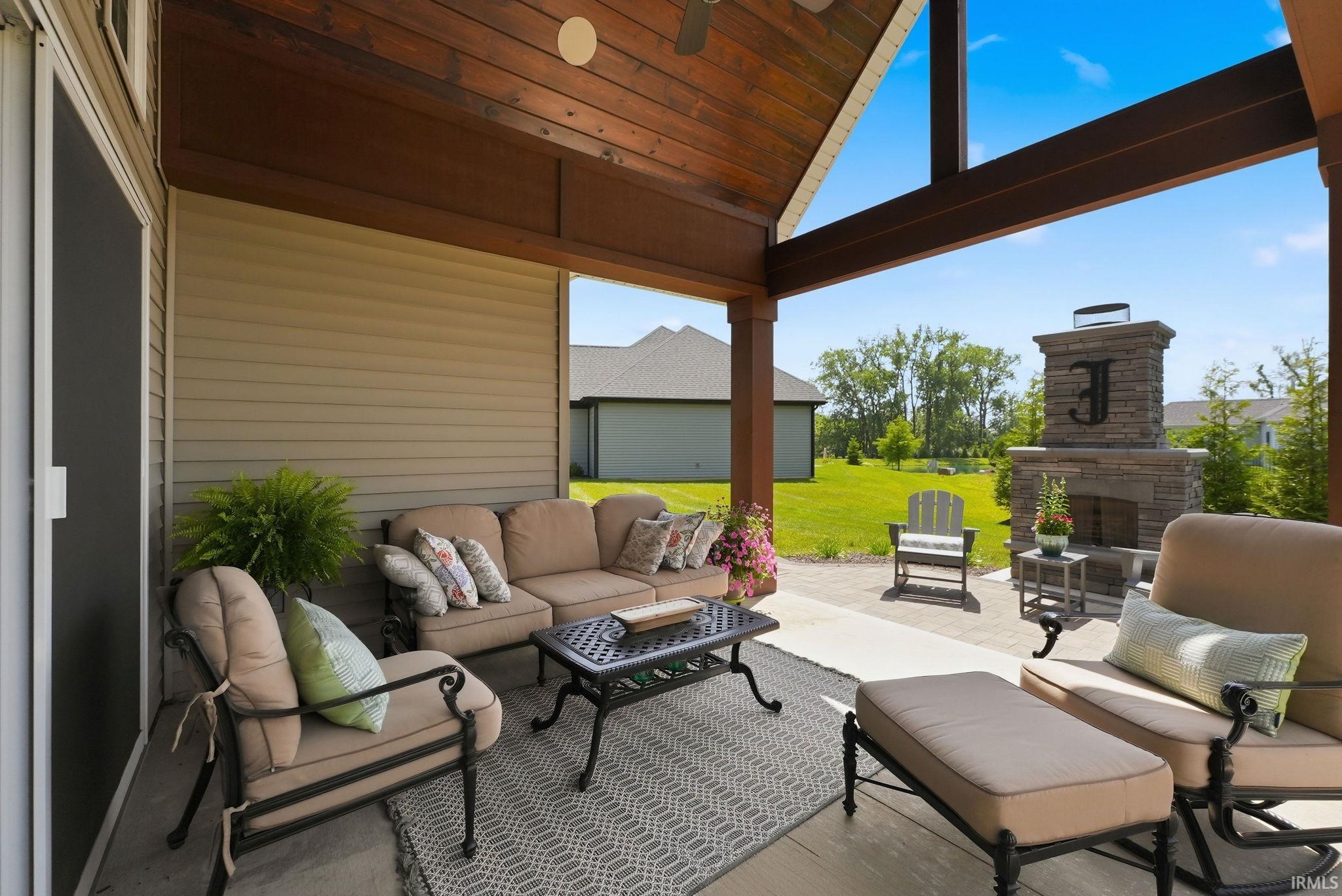 Covered patio featuring a high vaulted wood-plank ceiling