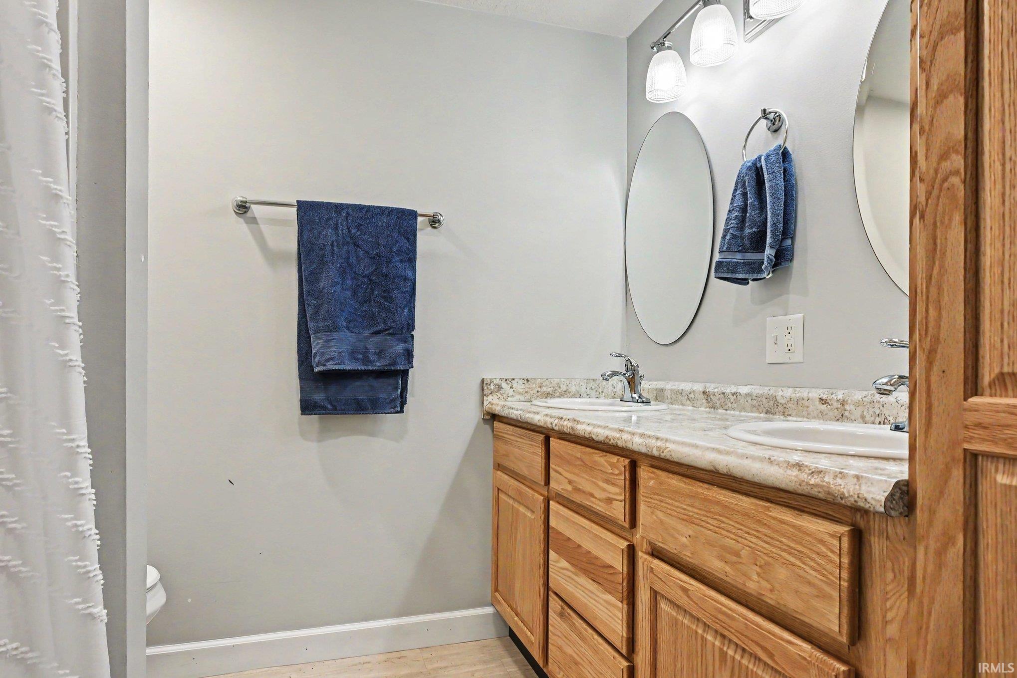 Double vanity with under-mount sinks and wood cabinetry