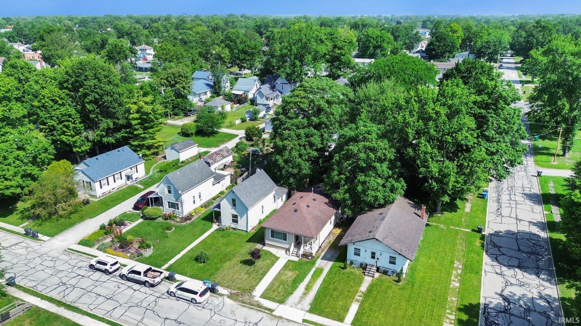 Residential neighborhood featuring mature trees and individual single-family homes with pitched roofs
