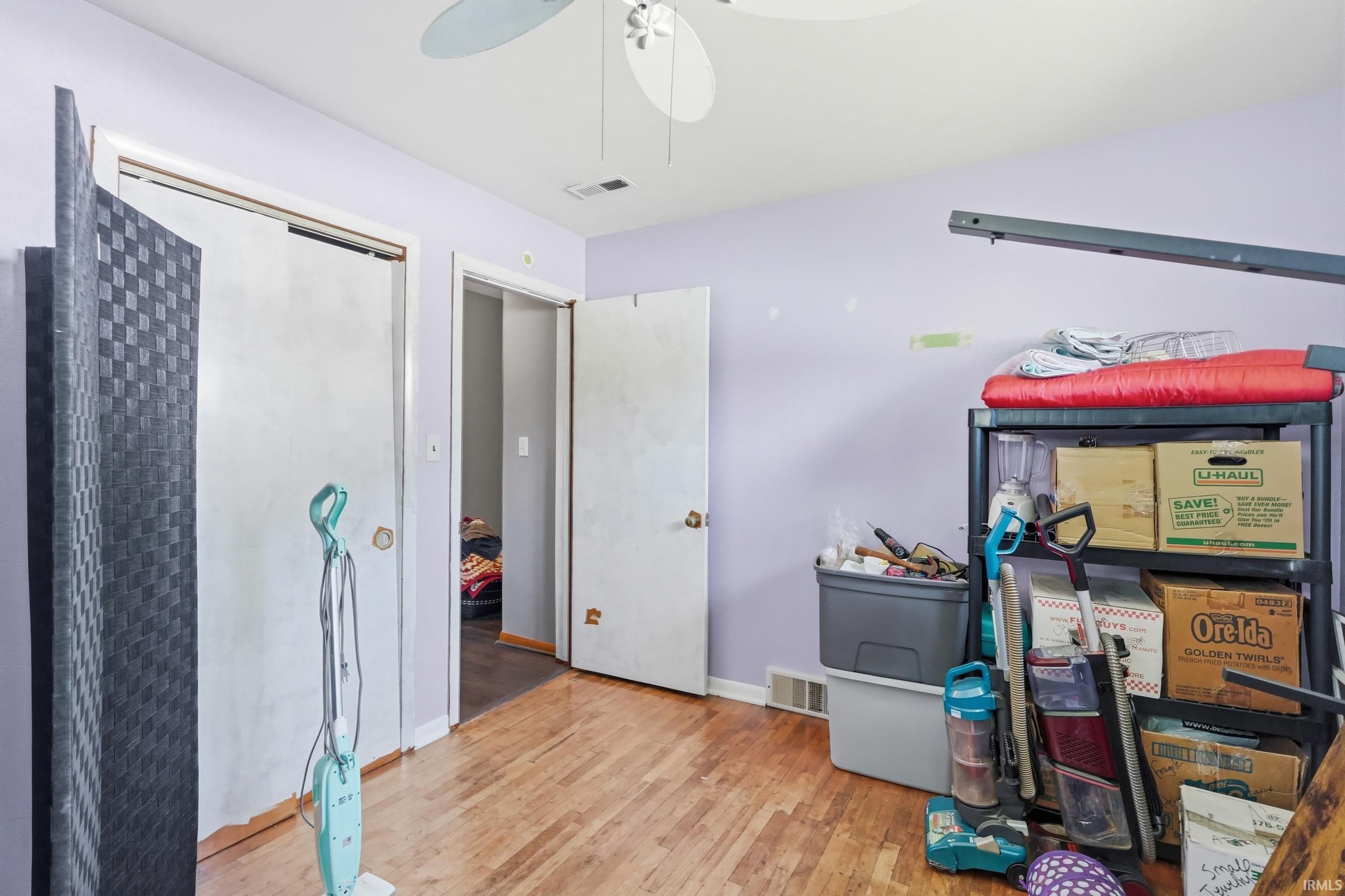 Hardwood flooring present in this room with a ceiling fan