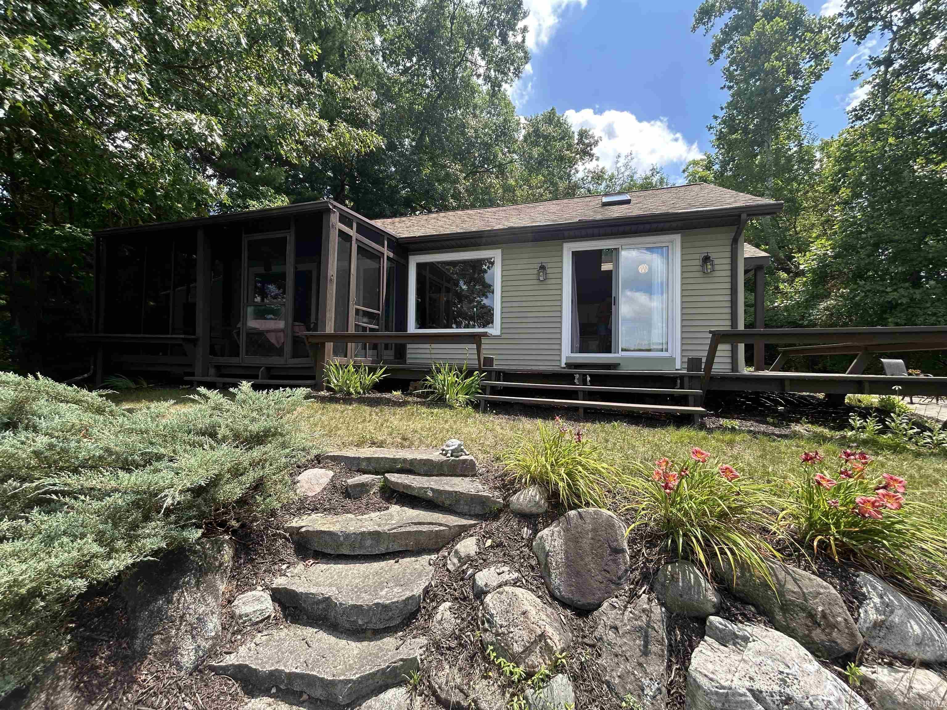Contemporary exterior featuring horizontal siding and a screened porch