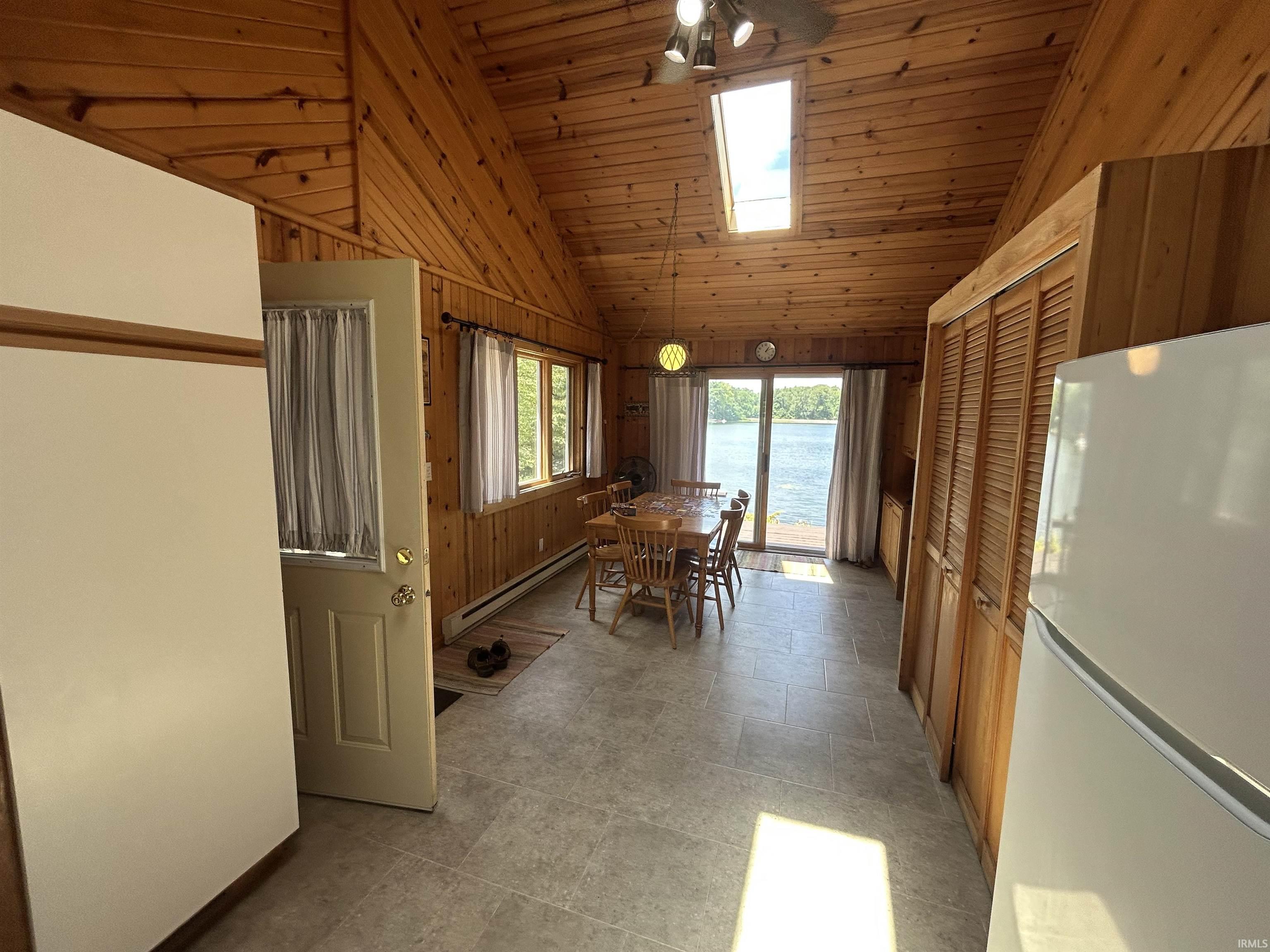 Vaulted wood-paneled ceilings with skylight
