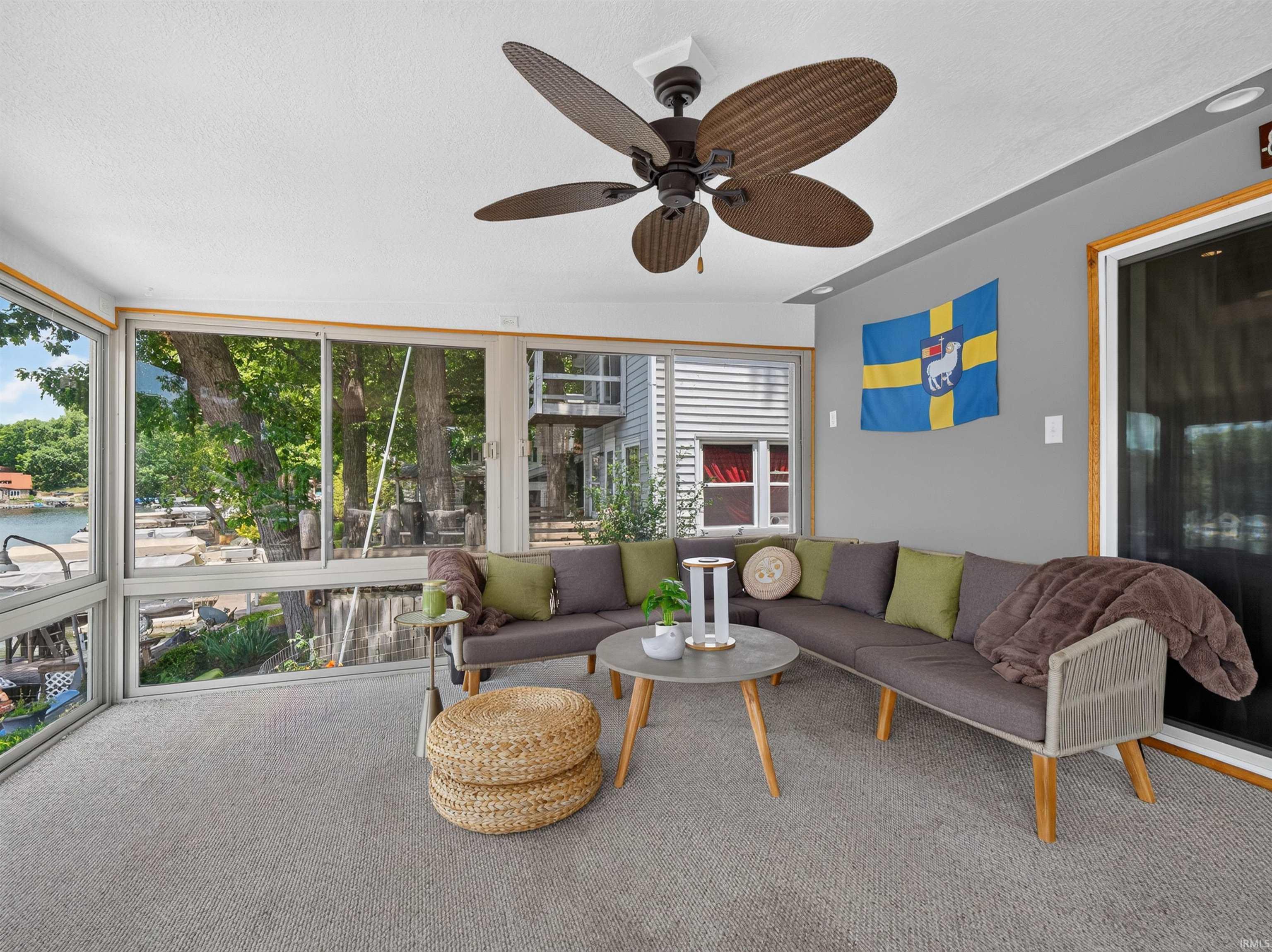 Sunroom featuring expansive windows, recessed lighting, a ceiling fan, and carpeted flooring