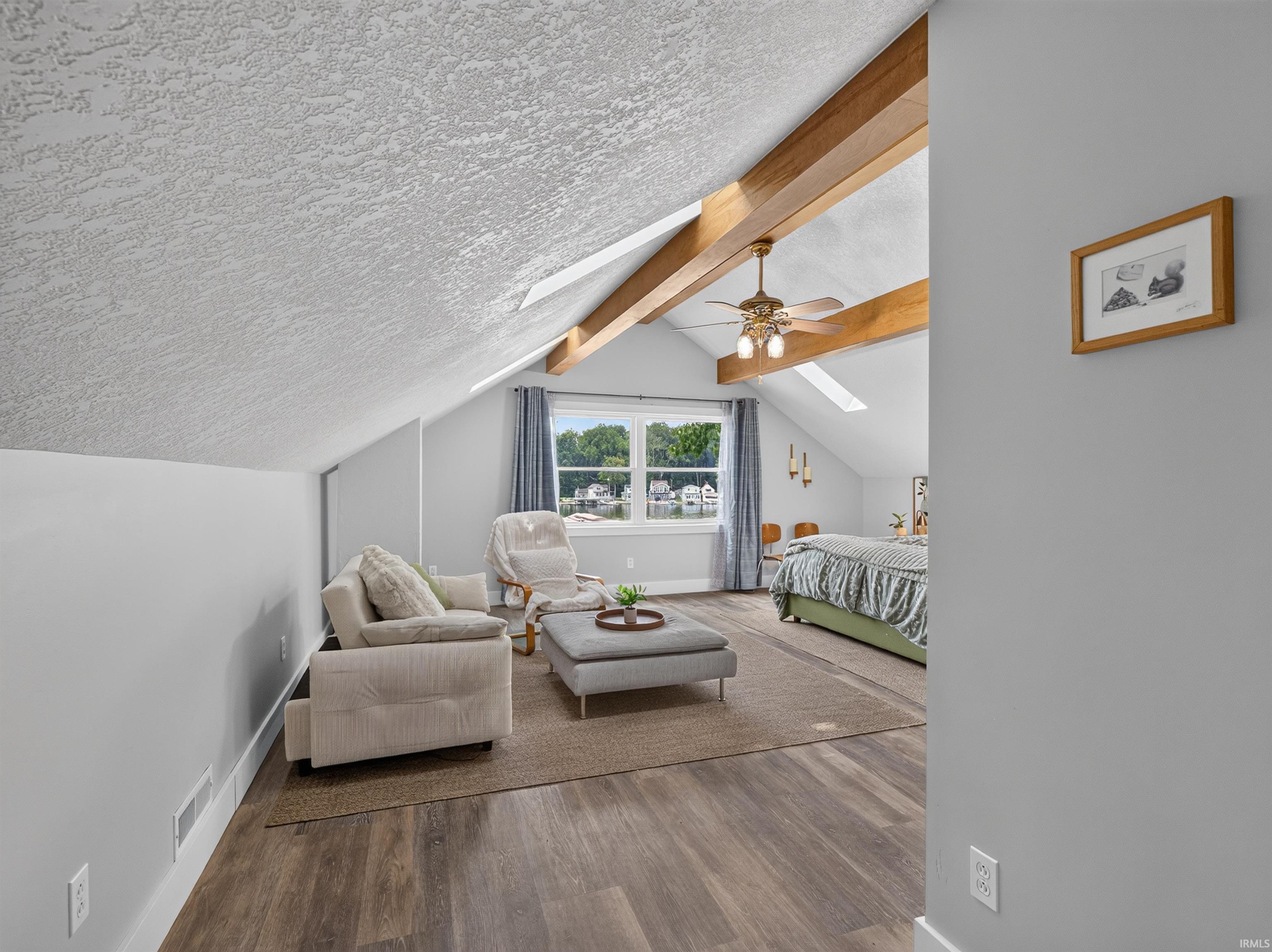Attic space featuring exposed wood beams and wood-finish flooring