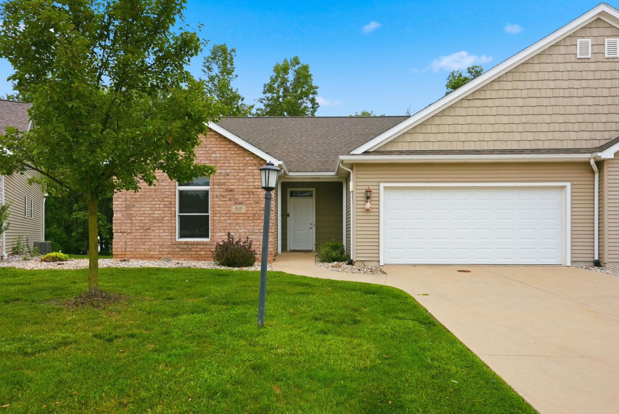 Exterior featuring a brick and siding facade with a two-car garage