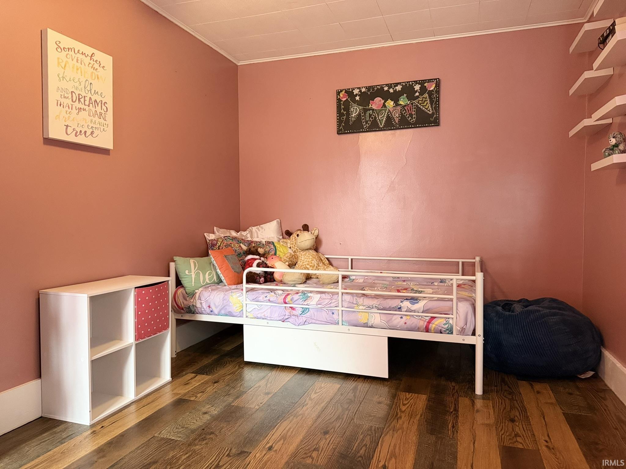 Interior room featuring wood-finish flooring and a textured ceiling